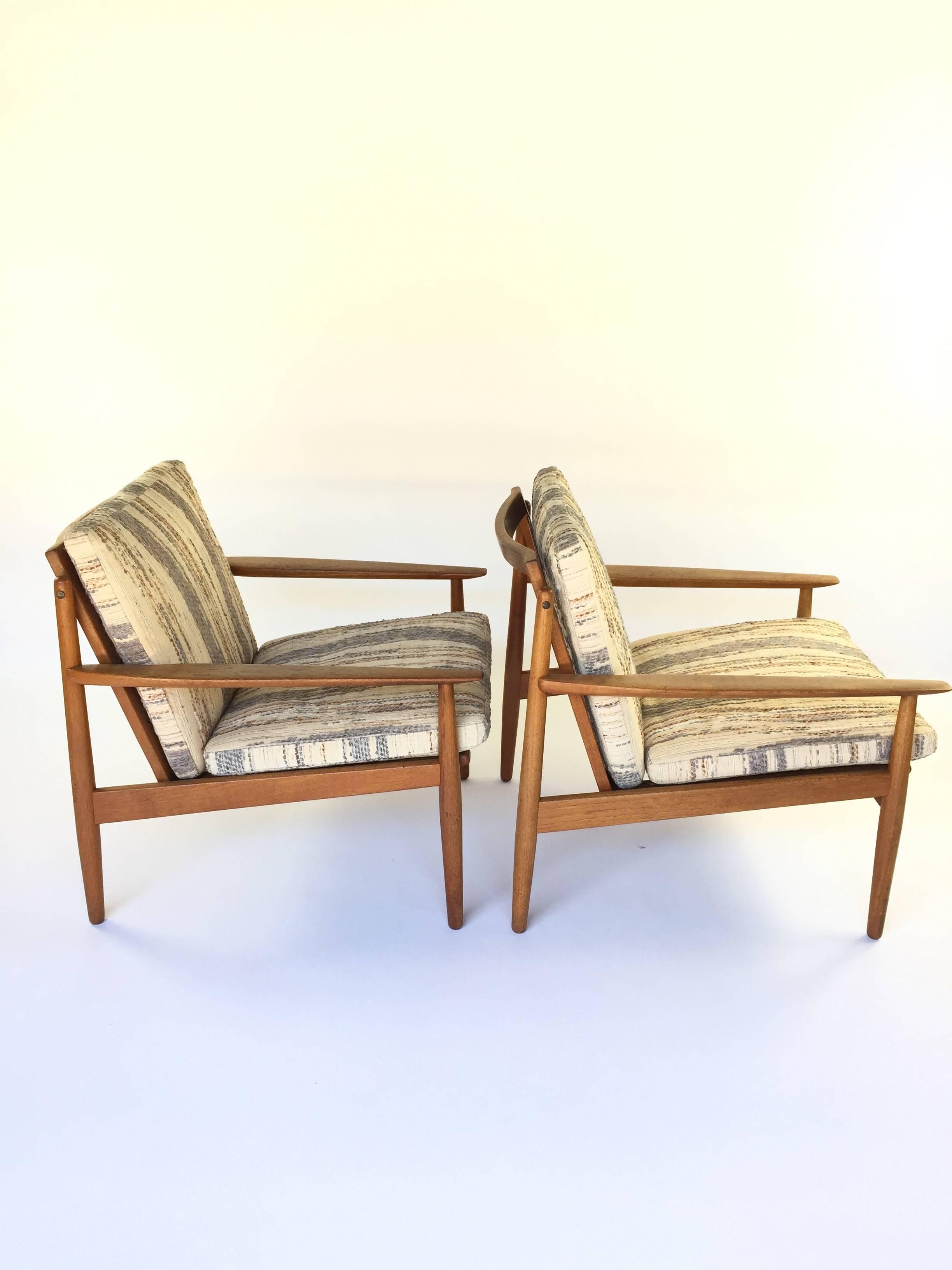 Pair of Danish teak chairs designed by Arne Vodder, circa 1960. Upholstered in embroidered wool/cotton blend.