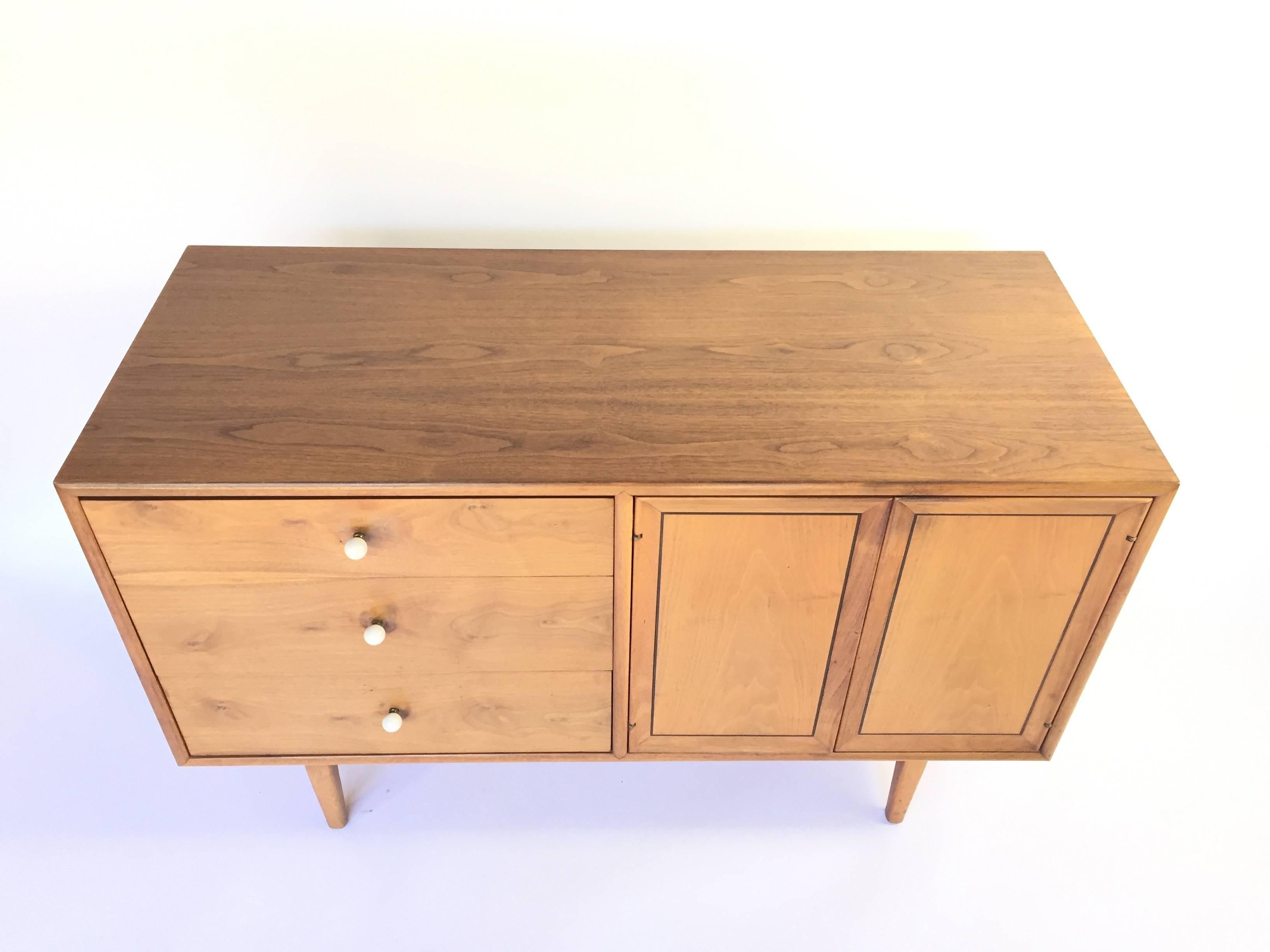 Beautiful Mid-Century Modern walnut dresser by Kipp Stewart for the Drexel Declaration collection. A timeless Mid-Century classic. Three drawers with original porcelain knobs and brass spacers. Top drawer is felt-lined and has dividers for