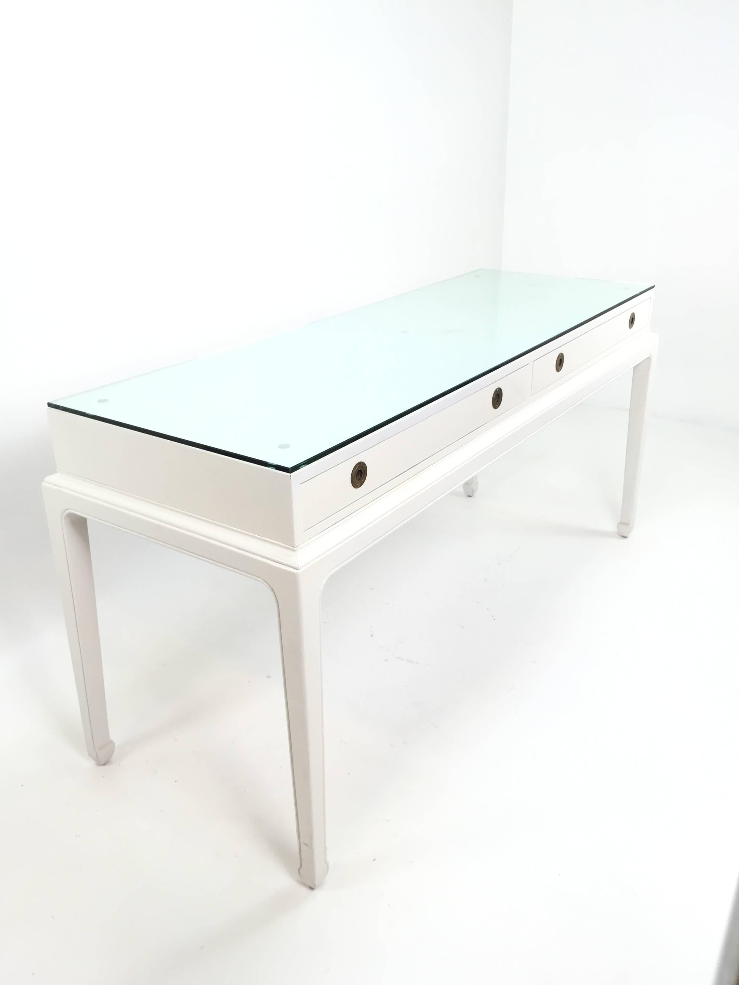 Asian Modern Campaign style desk or console for Henredon. Laquered in antique white. Desk or Console with recessed brass ringlet pulls. Thick glass top (Can be removed.) 