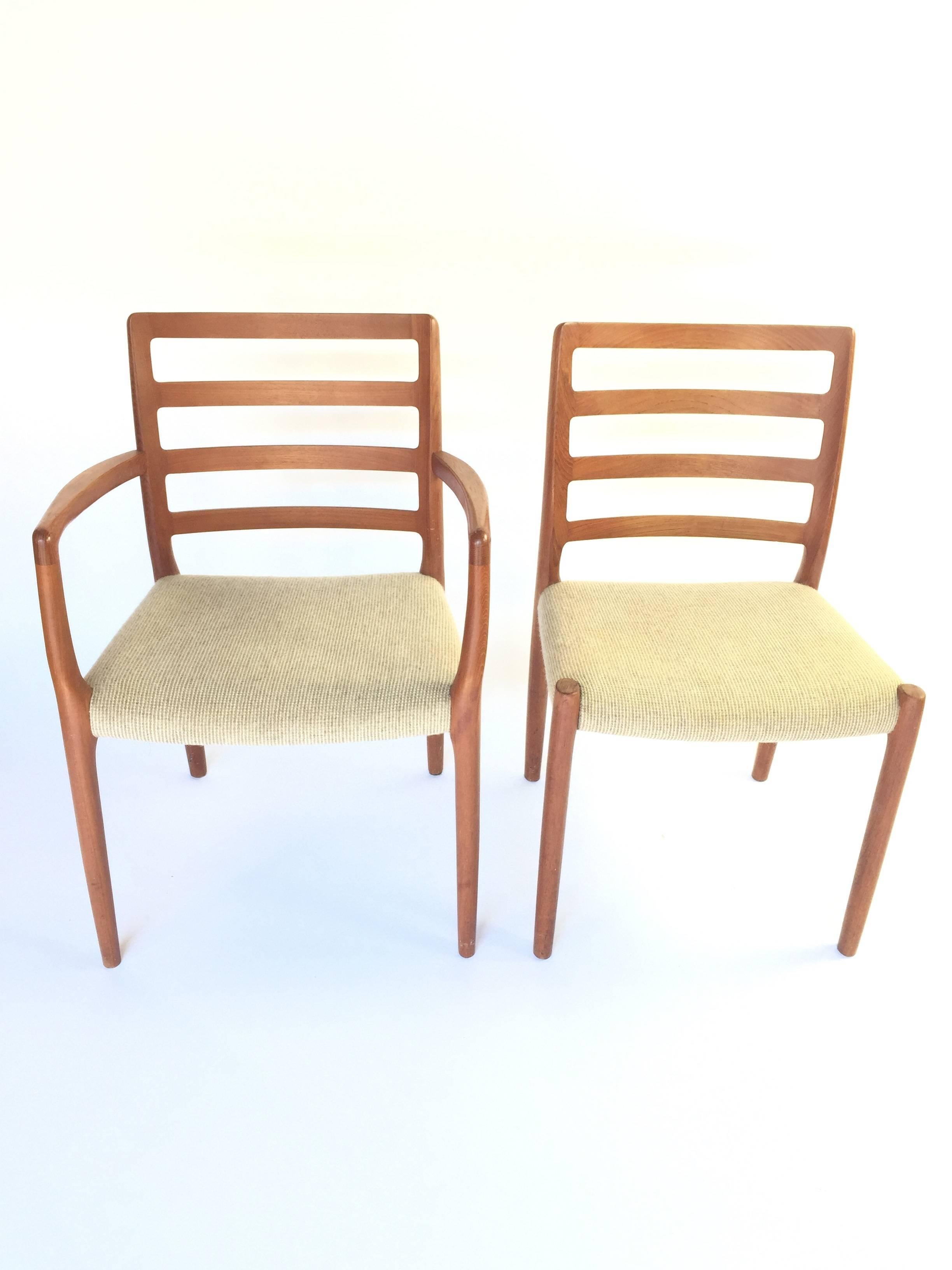 JL Moller teak model 85 dining chairs. 
Set of six including two armchairs and four side chairs. 
Original wool upholstery.
