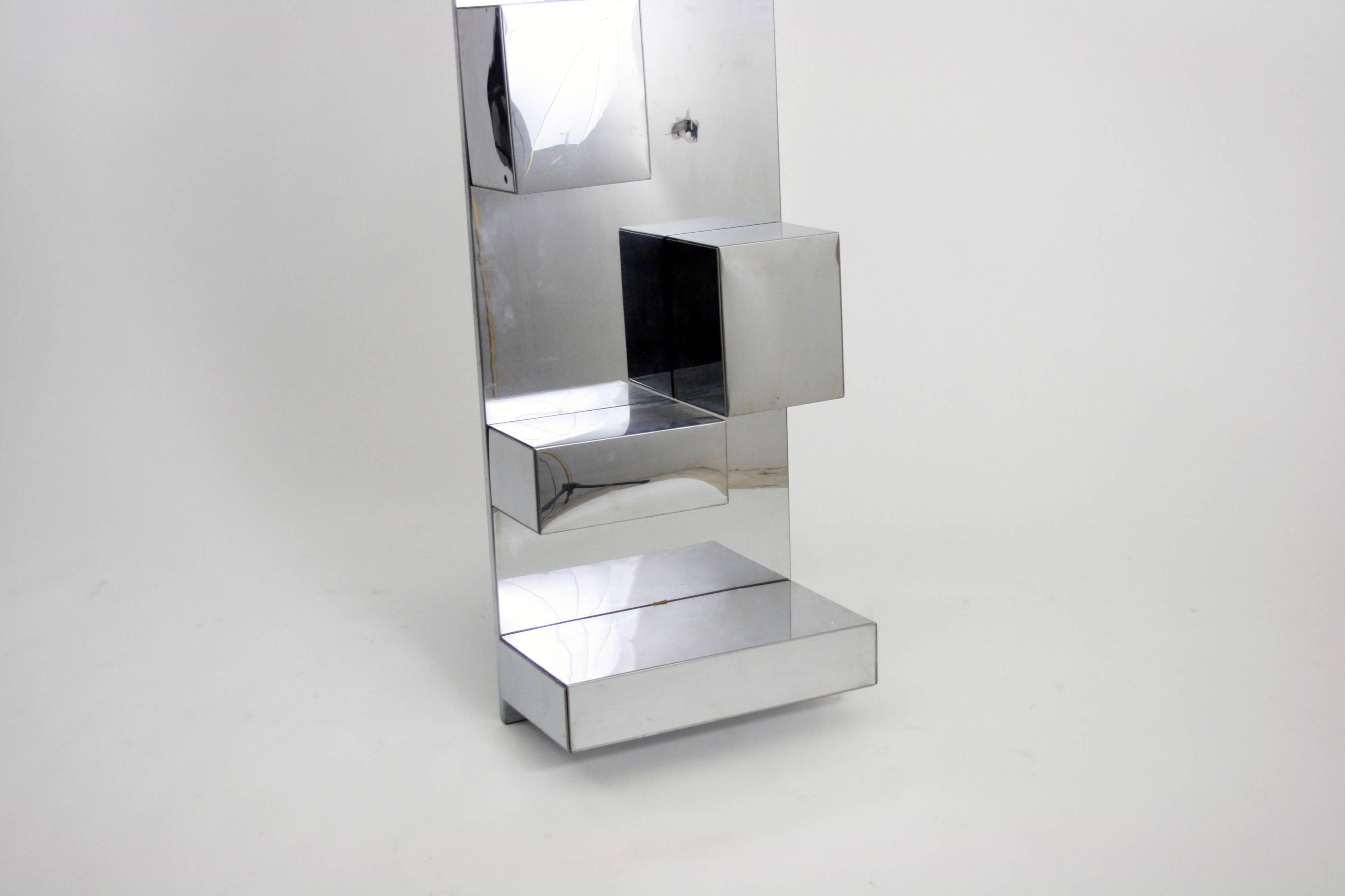 Geometric polished aluminium wall sculpture or shelf attributed to Curis Jere in excellent condition circa 1970s. This piece looks amazing and each folded aluminium shelf can be removed to hand the main support so that it floats on the wall.