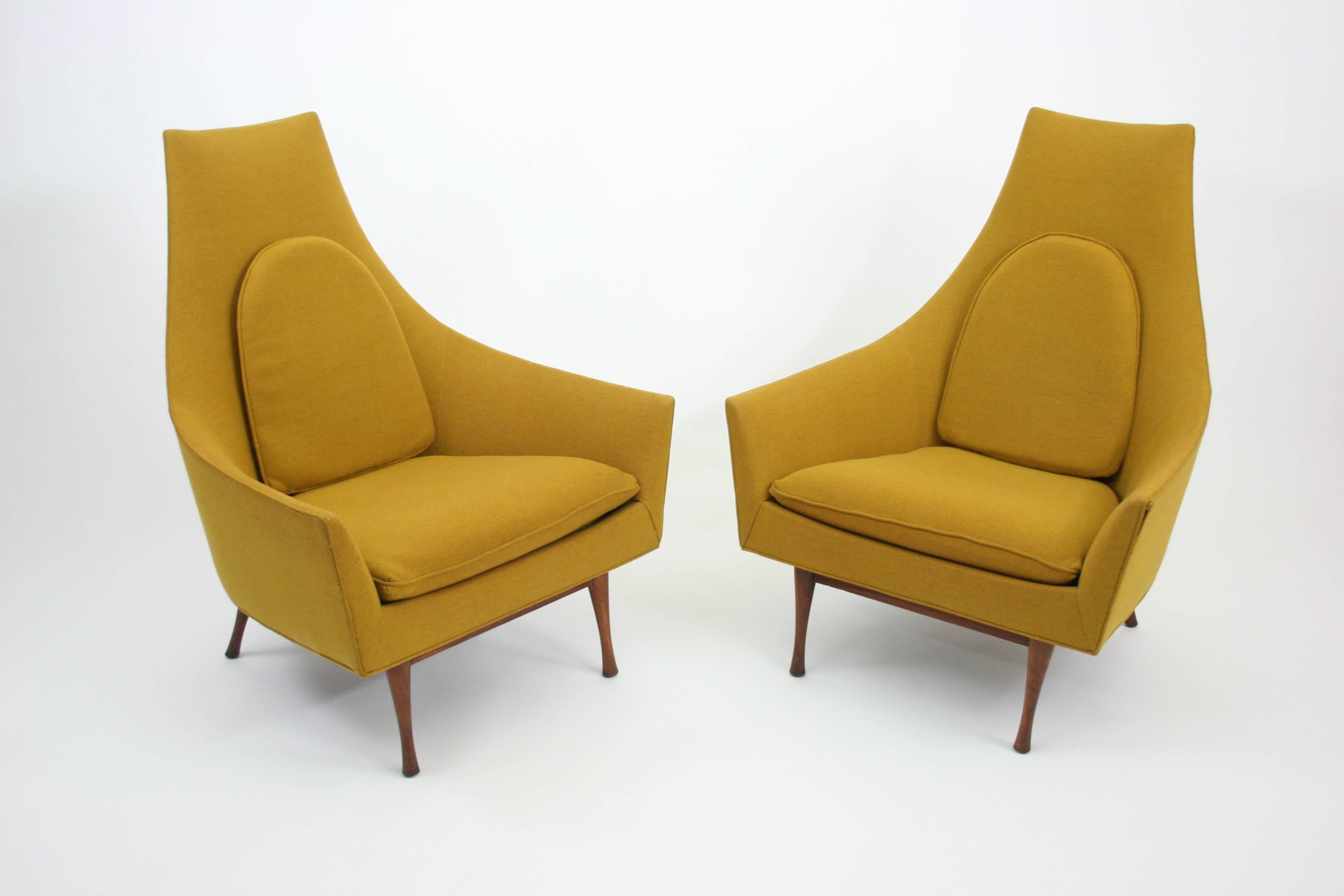 Amazing matched pair of Paul McCobb lounge chairs for Widdicomb Furniture Co. In an original wool fabric, these chairs are nothing short of amazing. Beautiful lines on these sweeping frames that float upon solid walnut legs. Completely solid