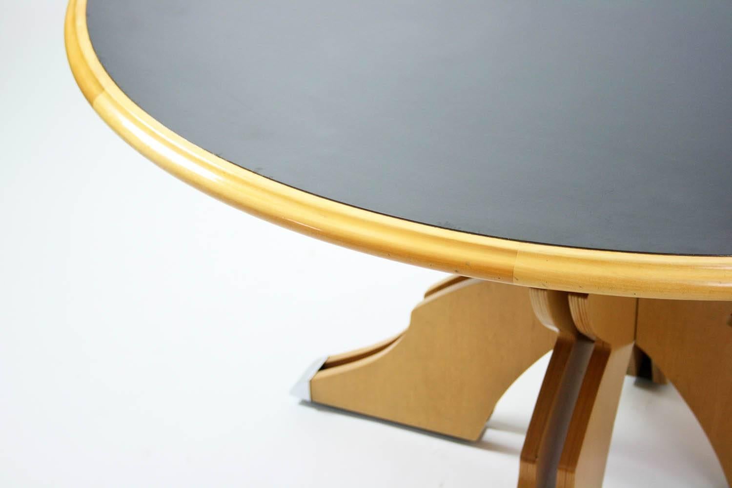 Robert Venturi Queen Anne dining table for Knoll International, USA, 1979-1984, featuring a leather top. Constructed of plywood, leather, rubber and chrome-plated brass.

Dimensions: 60" W x 29.5" H.