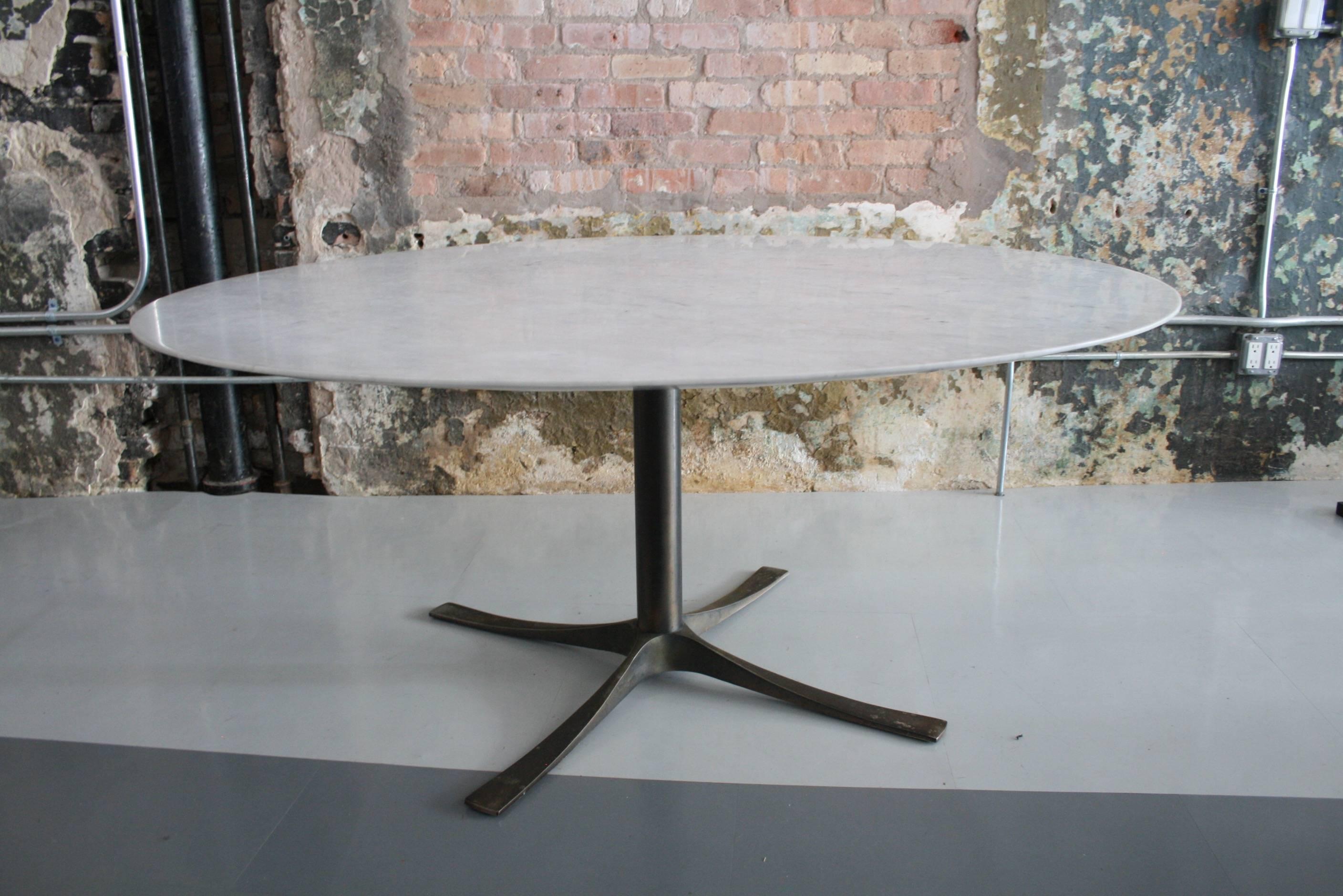 56" diameter knife edge Carrara marble dining table on bronze base designed by Architect Ron Dirsmith. 

 