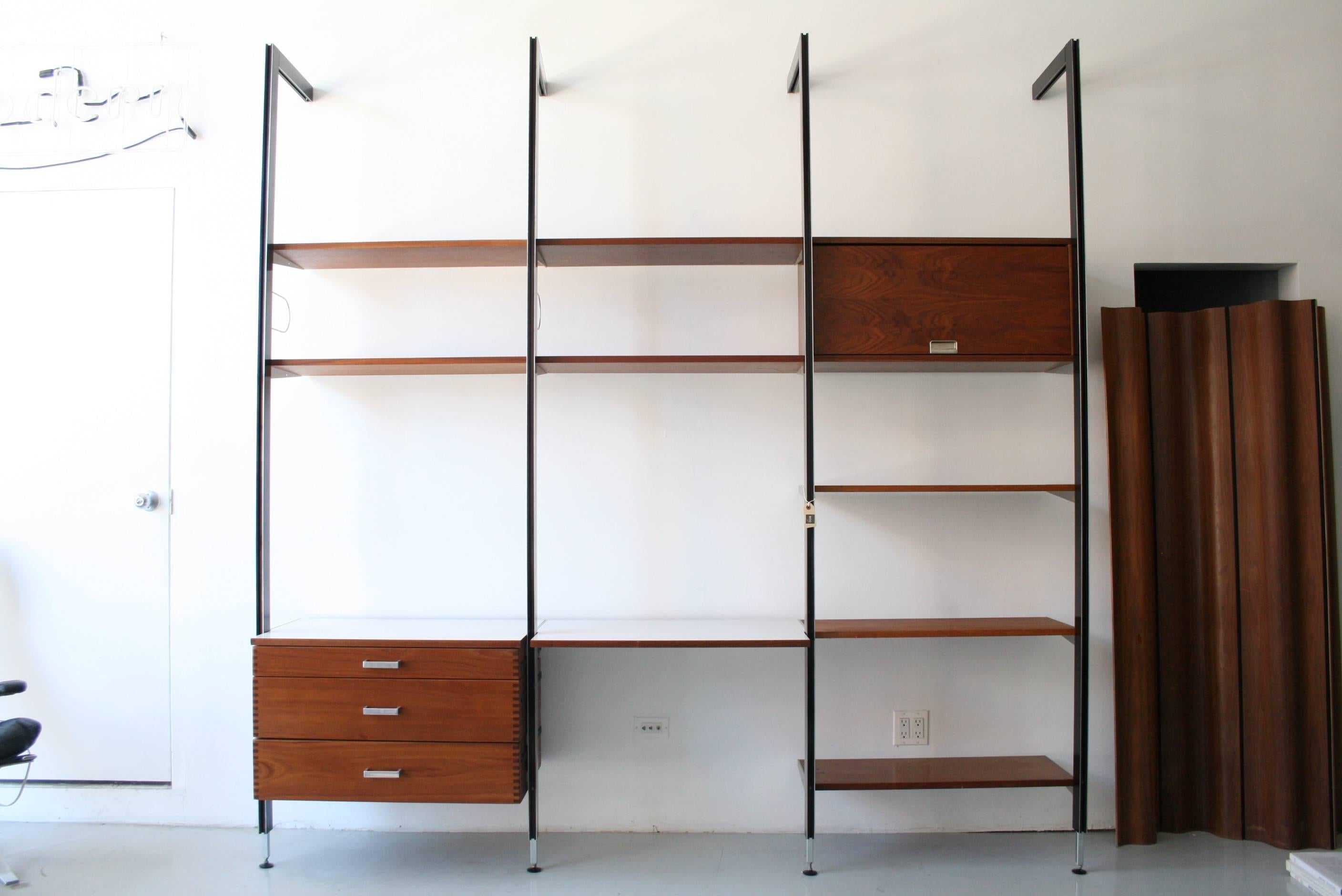 This design is truly amazing! A set rarely seen in such great condition and so complete. Equipped with some of the more interesting CSS components. This wall unit includes four black uprights with tieback supports, three drawers with hardware, two