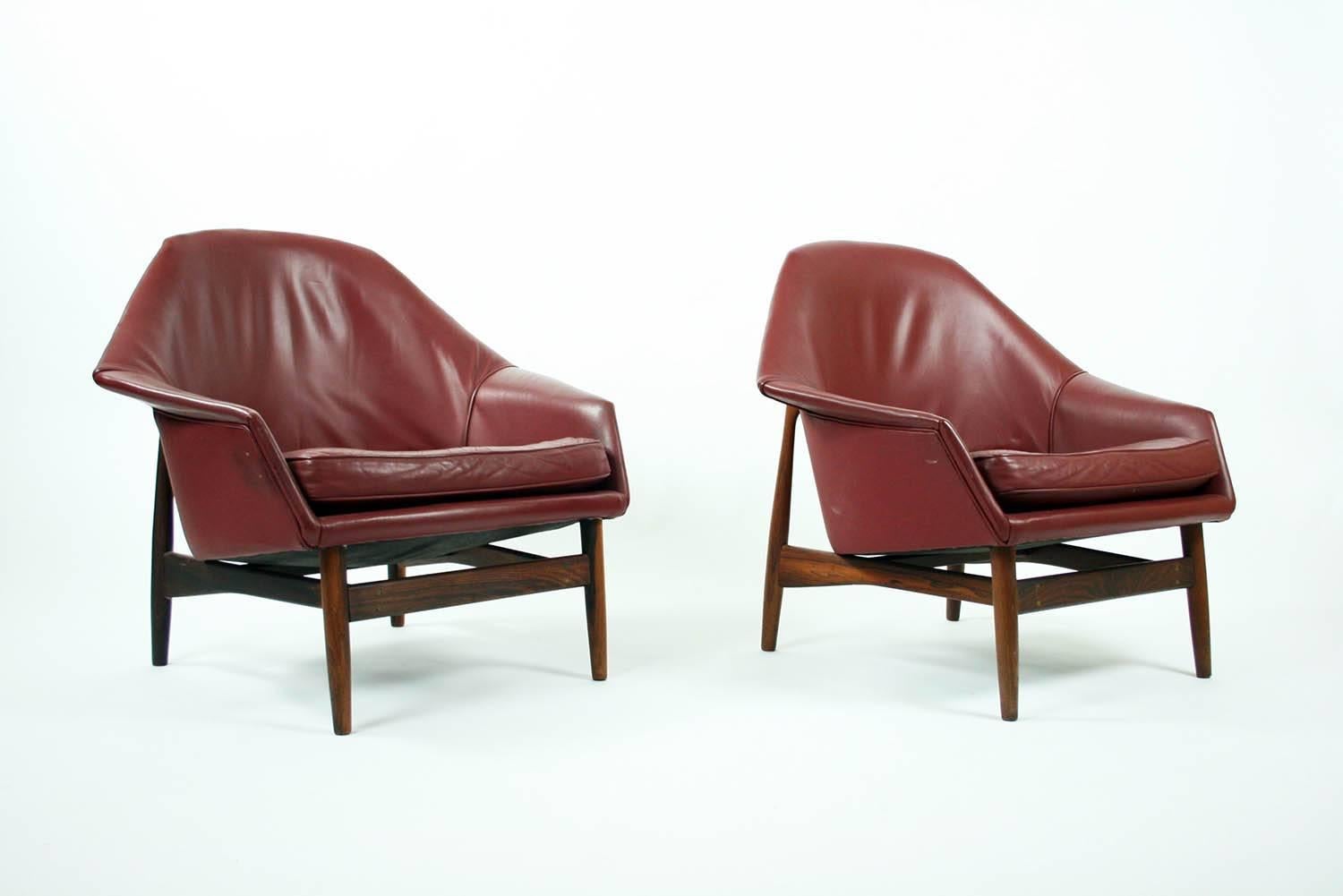 Two sculptural rosewood and leather lounge chairs designed by IB Kofod Larsen for Carlo Gahrn, Denmark. Chairs and in very good condition and very comfortable. The design is documented 1957 in Danish magazine "Mobilia".