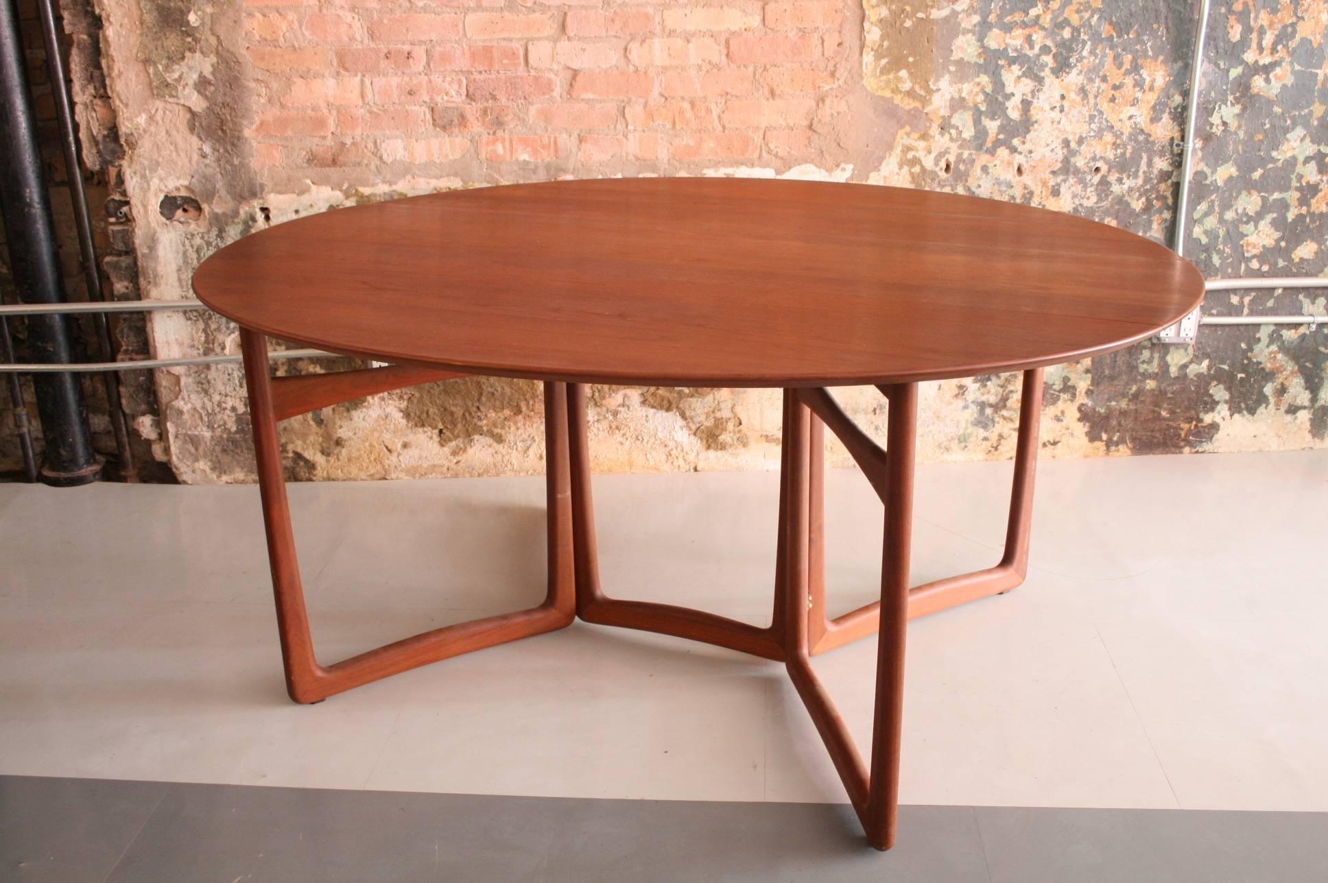 A beautiful teak dining table with drop leaves. Expands and minimizes with ease and a slight movement. Beautiful patina. Fully Marked France and Daverkosen.