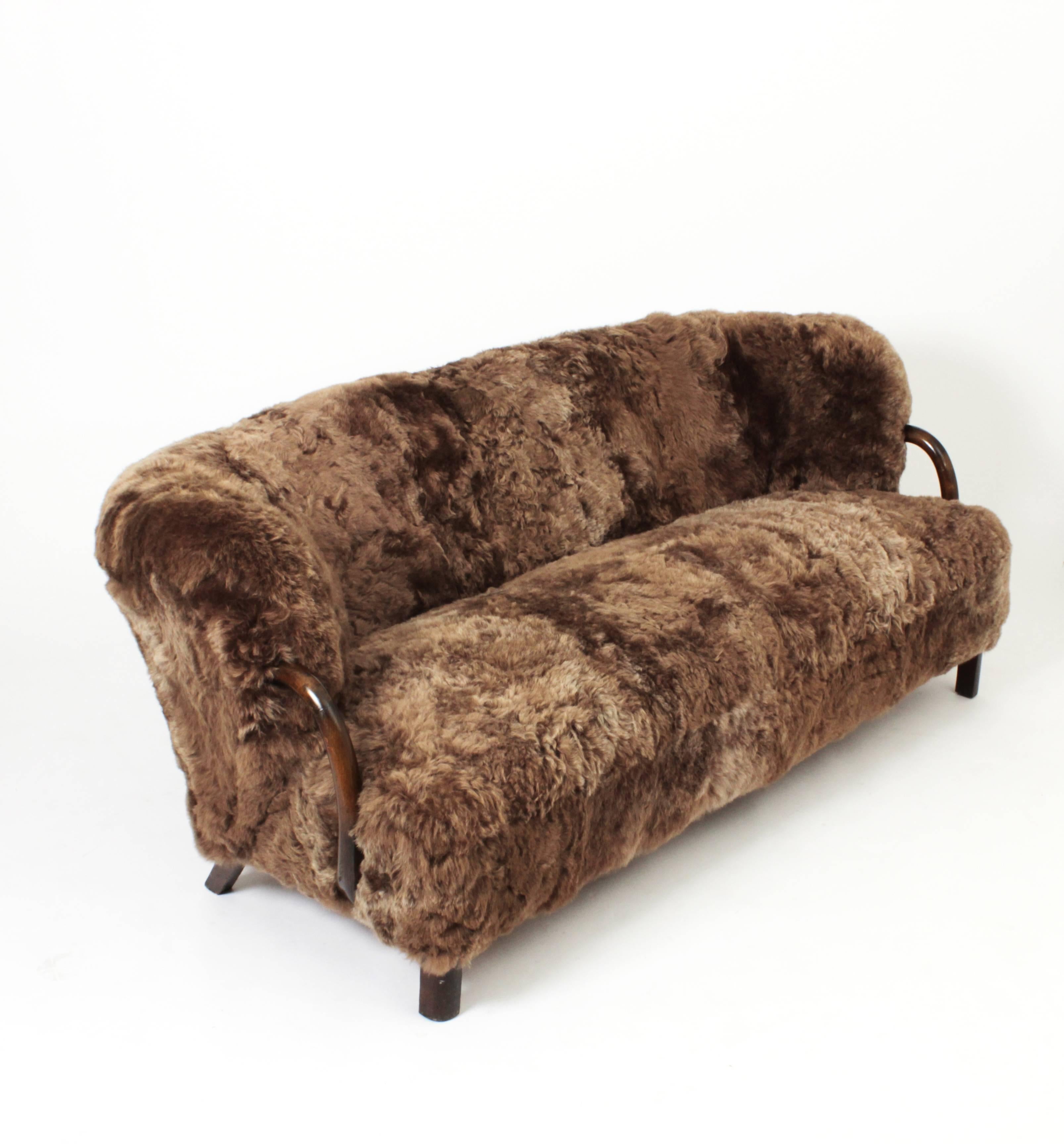 Three-seat sofa by Viggo Boesen and made by Slagelse Møbelværk, Denmark, circa 1935.
Newly upholstered in brown Icelandic sheepskin and dark stained oak and legs.

Literature: Slagelse Møbelværk katalogue 4401, p. 27 and 30.