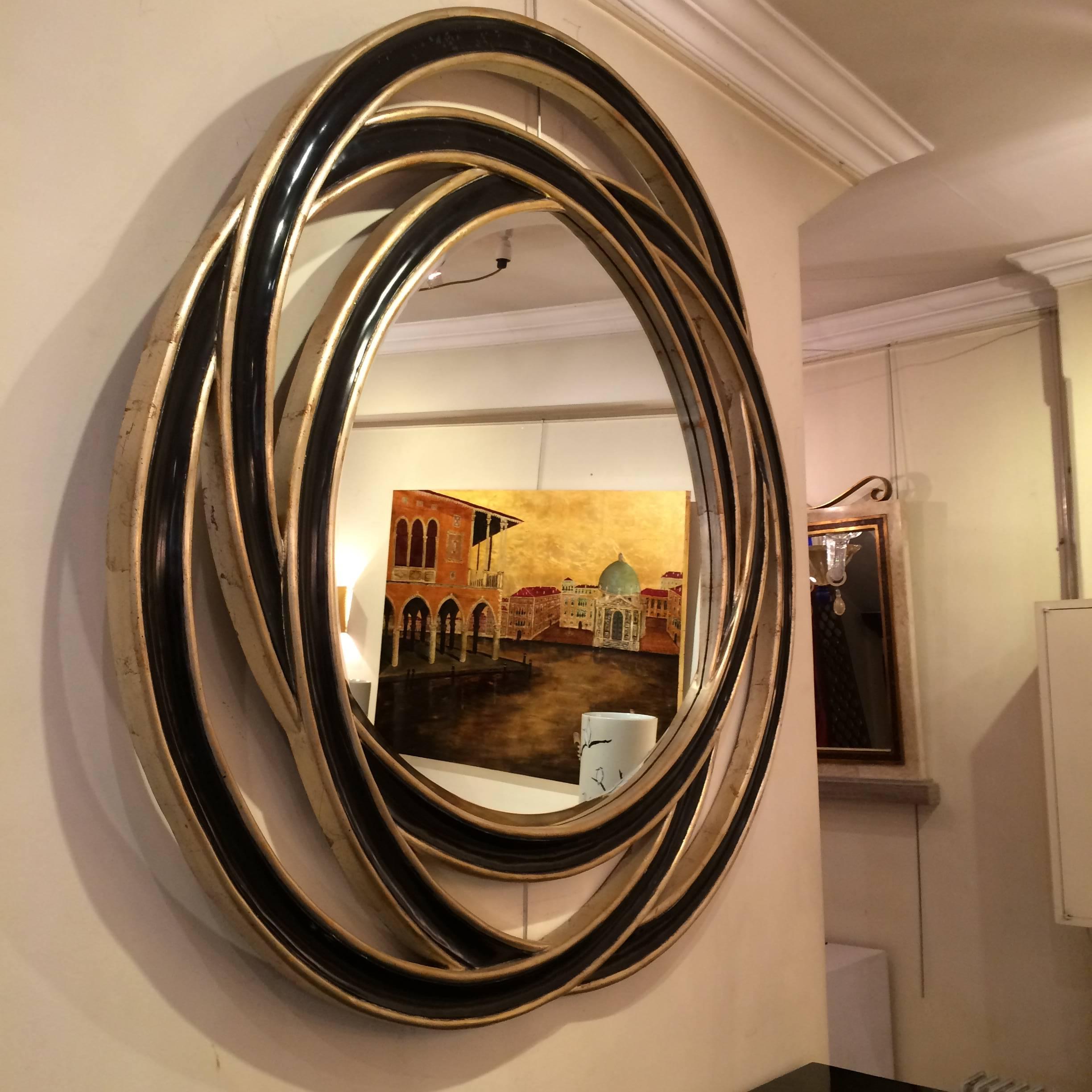Big mirror in lacquered wood, black and silver patine.