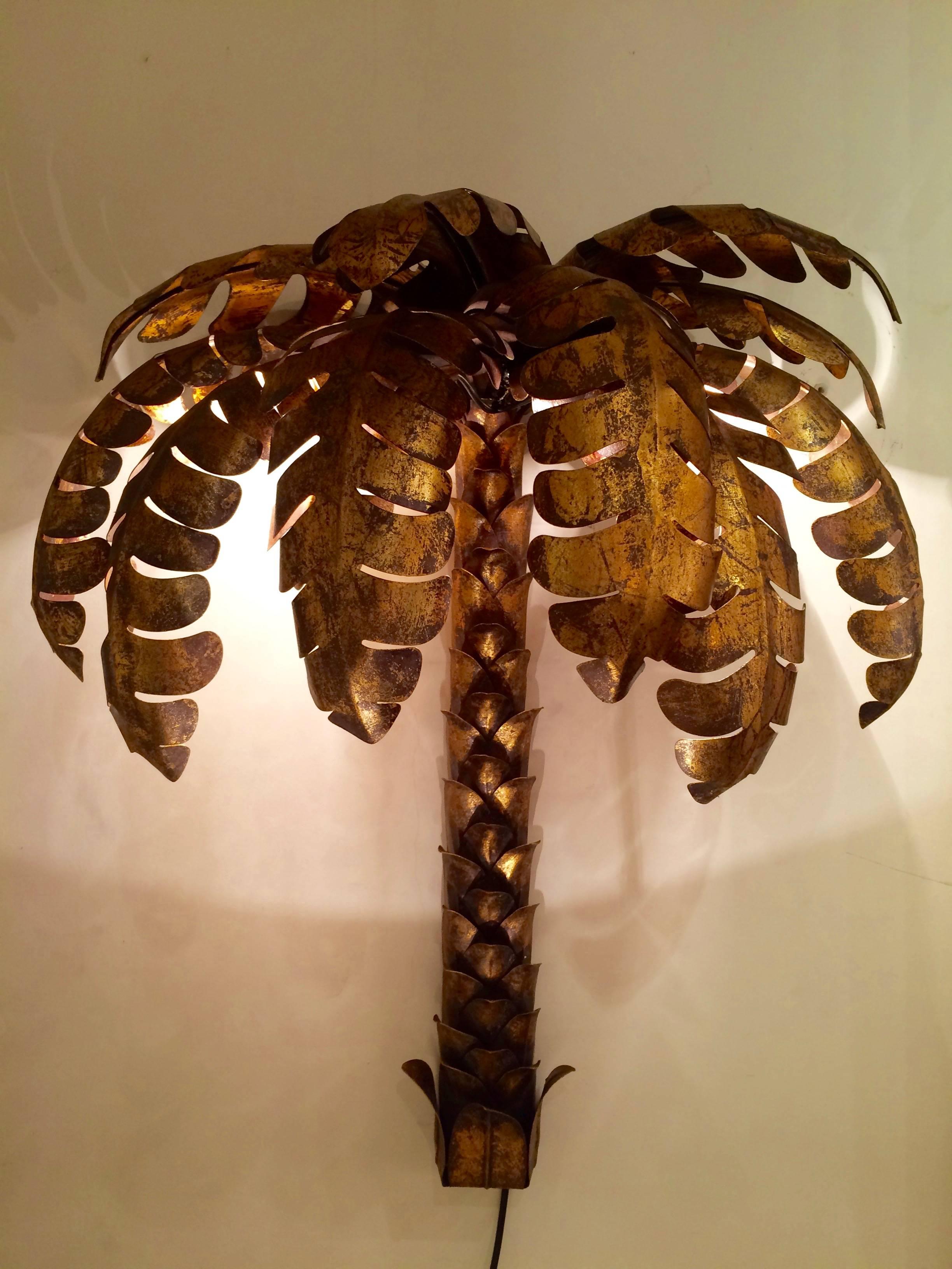 Very decorative set of palm tree sconces in the style of Maison Jansen, Paris
in wrought iron with a gold leaf patine.
We have eight items and they are sold by set of two.
The price indicated is for one sconce only.