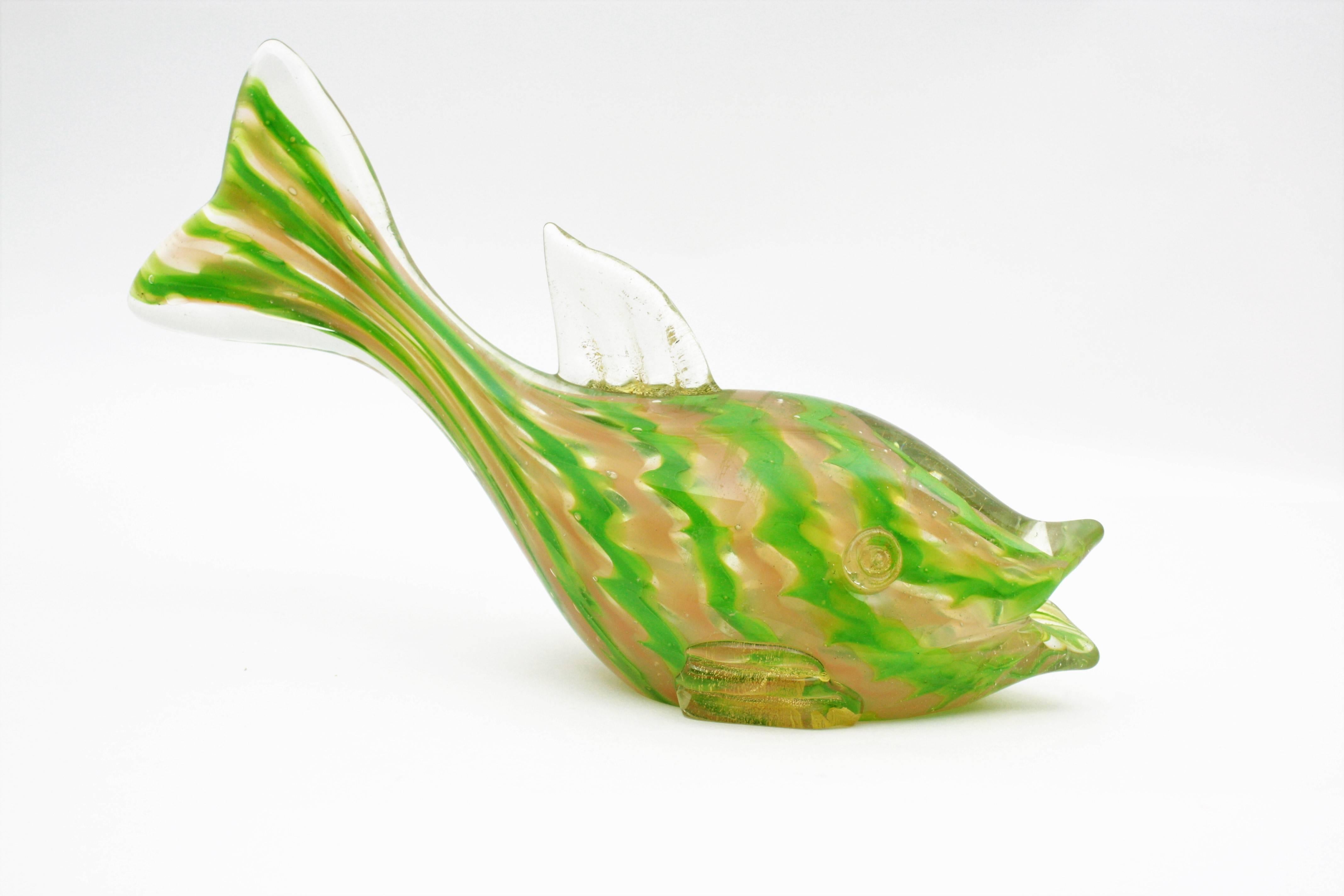 Gold Flecks Acid Green & Cream Ribbons Murano Art Glass Fish Figure, Italy 1940s
A lovely Murano glass fish sculpture with colorful ribbons in acid green and cream color cased into clear glass and gold dust accents,
Measures: 28 cm W x 19,5 cm H x 9