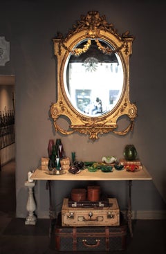 Grand miroir palatial Louis XVI du 19ème siècle en bois doré avec sculpture de feuillages