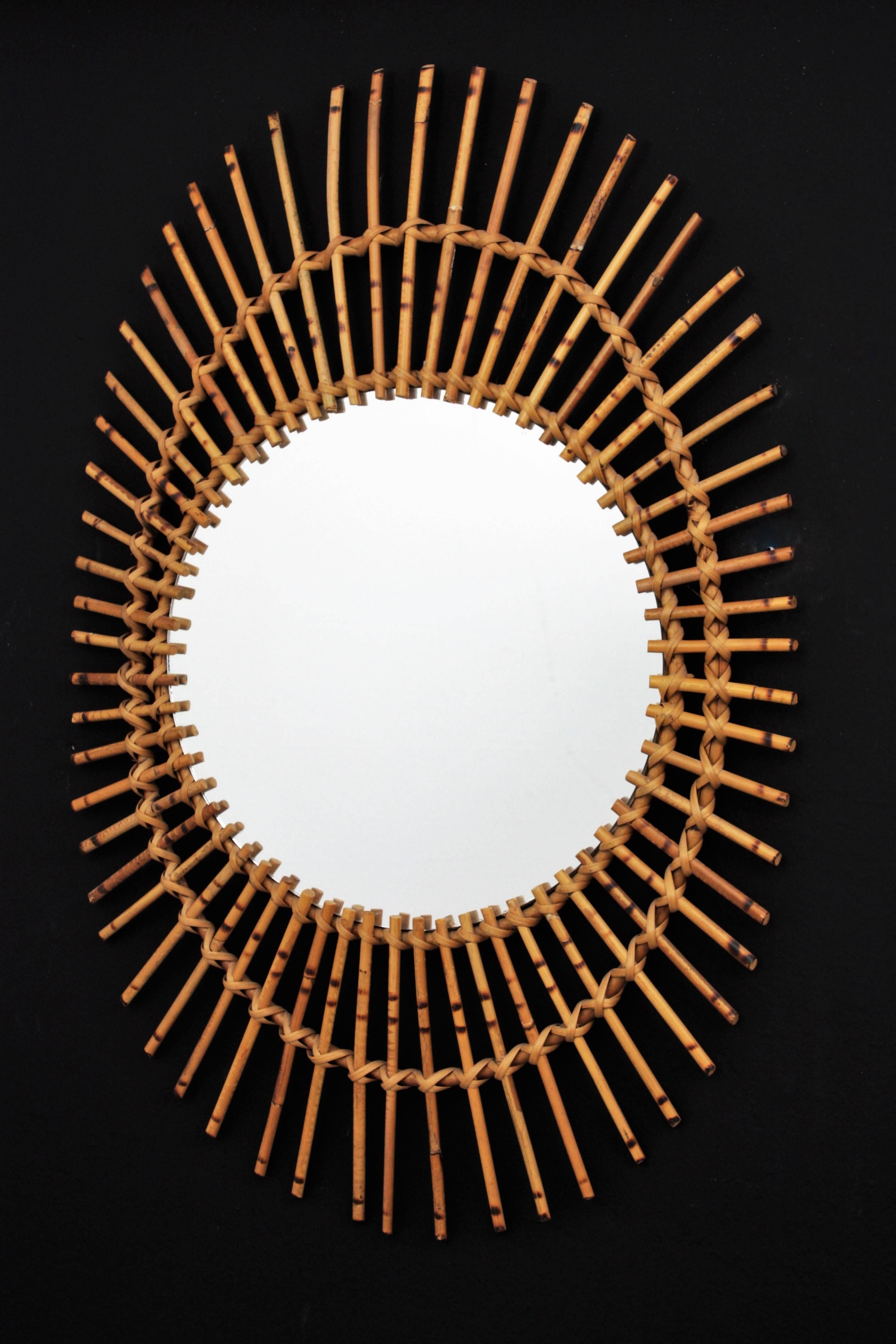 Hand-Crafted Mid-Century Modern French Riviera Rattan Asymmetric Oval Sunburst Mirror