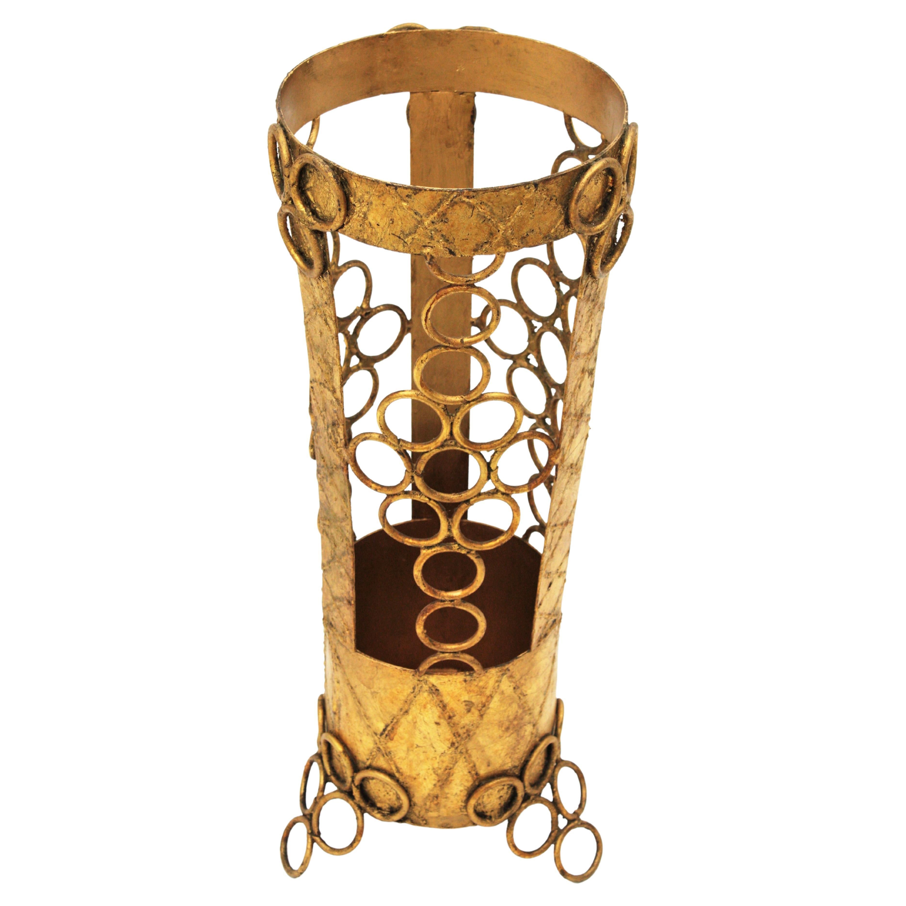 Hand-forged iron umbrella stand, Spain, 1950s.
One of a kind Brutalist style hand-hammered round umbrella stand with circles decoration and gold leaf gilt finishing. 
This artisan umbrella Stand is made from wrought iron, it has hammered rhombus