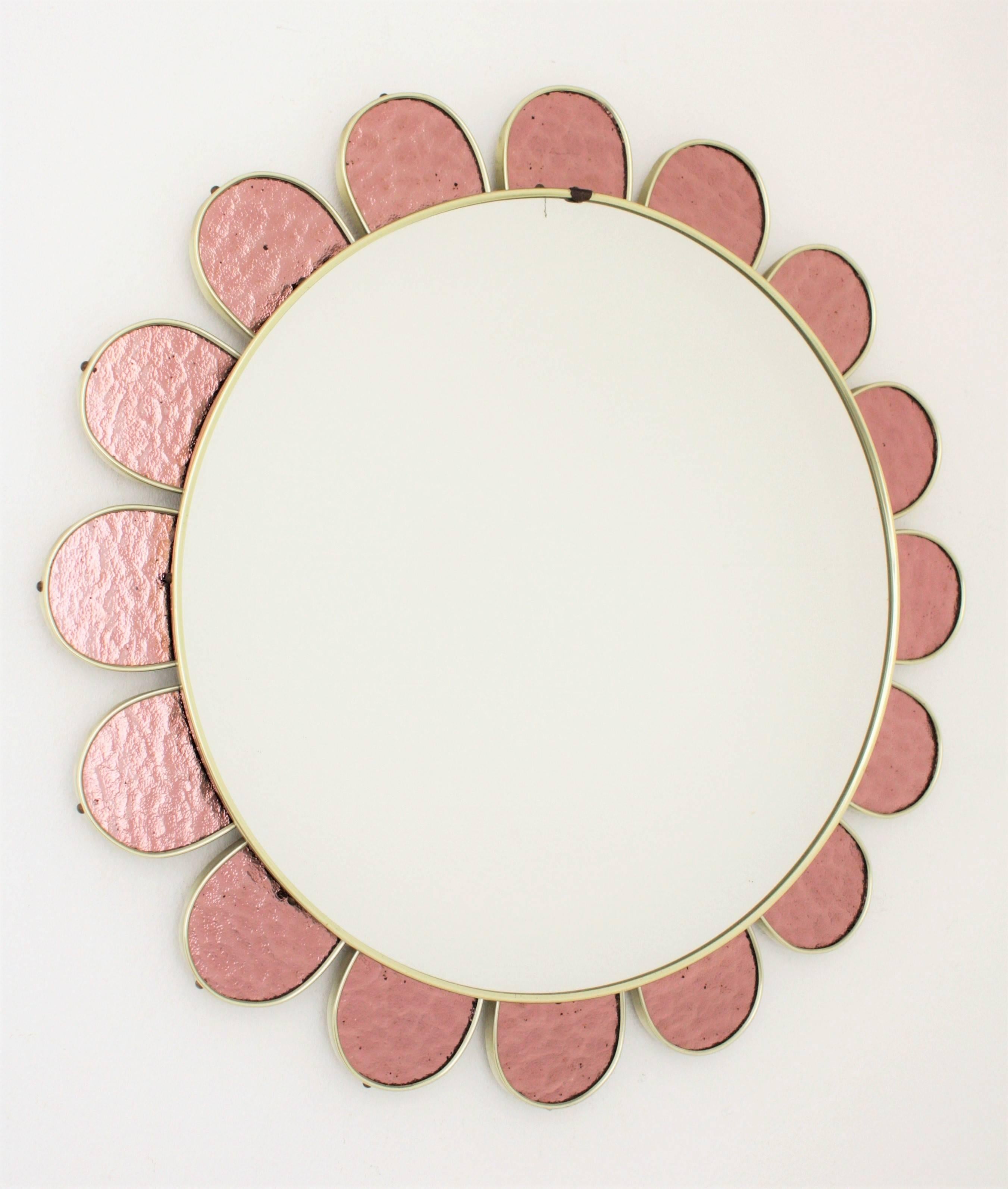 Flower burst mirror with petals frame made with pieces of iridescent pink glass.