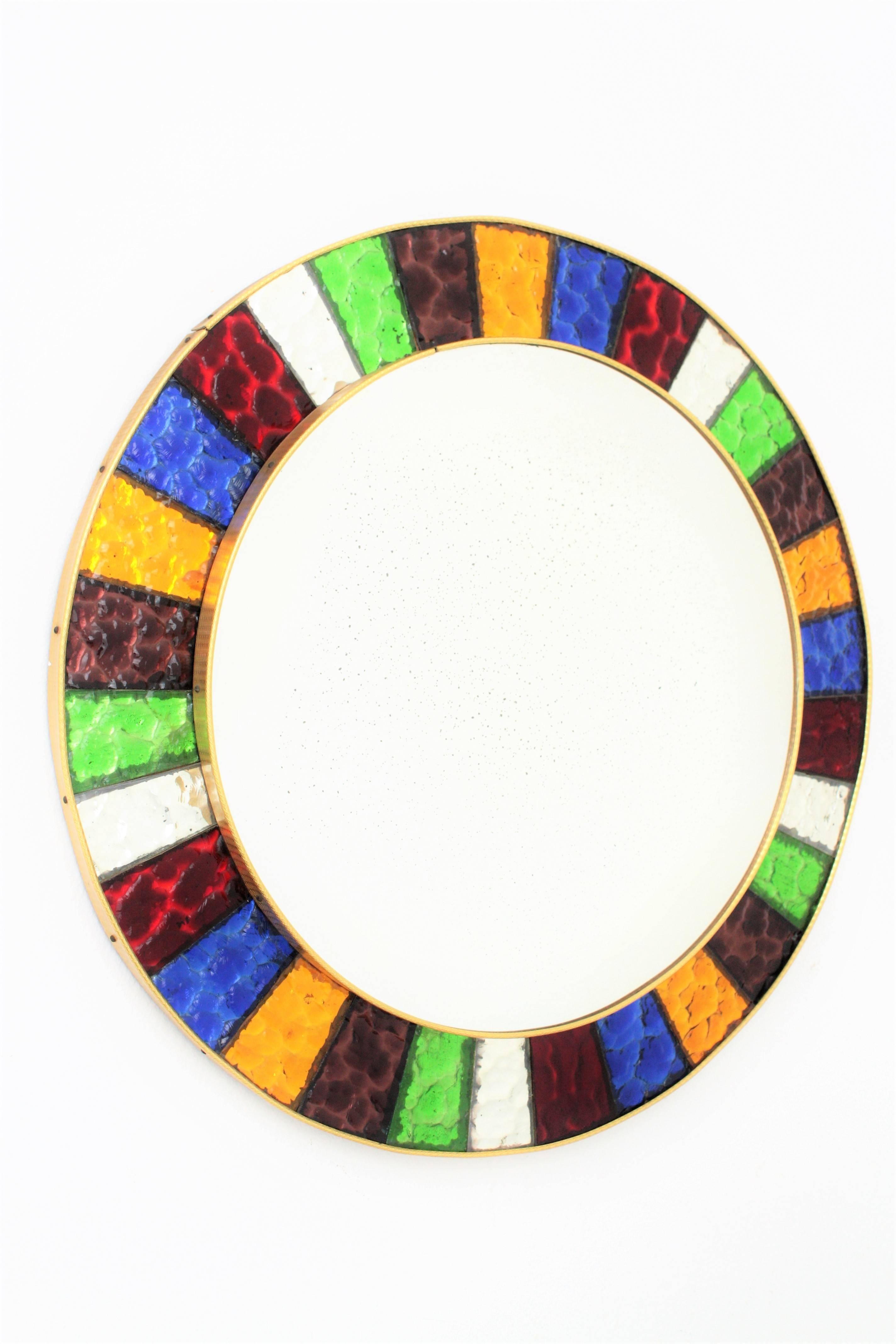 Highly decorative mirror composed by pieces of hand-cut mirrored glass in different colors surrounding. This piece is excellent condition and it was hand-crafted in Spain near 1960s.
Dimensions of the glass: 42cm diameter.
Some other mirrors in this