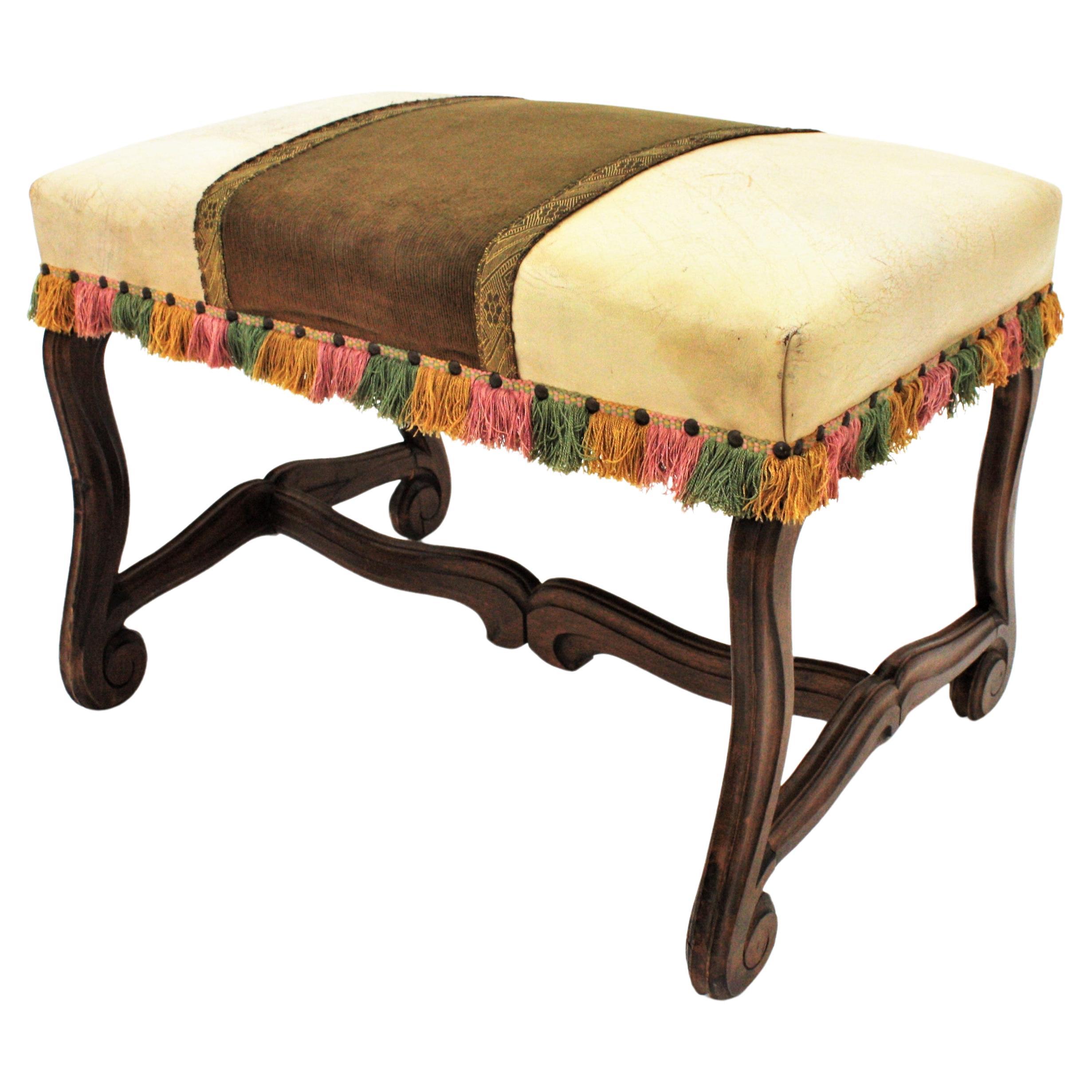 Spanish Louis XIV style Ottoman, 
Beautiful Louis XIV style bench or stool raised on four Os de Mouton hand carved walnut legs with stretcher, Spain, 1930s.
This stylish banquette has a stretcher joining the legs and scroll motif accents
It is in