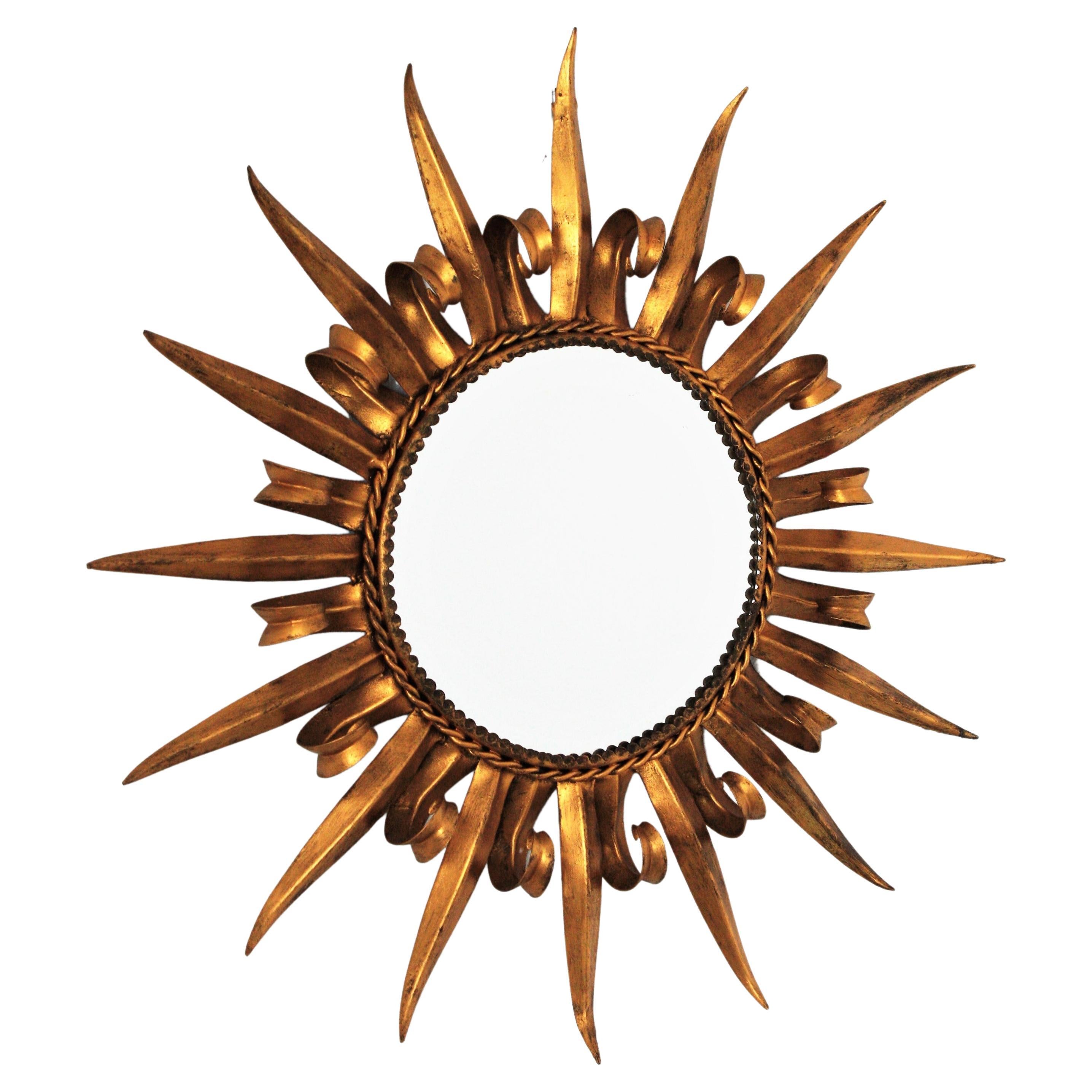 Gilt Metal French Sunburst Mirror Eyelash Design, 1950s
Lovely 1950s hand-hammered double layered eyelash gilt iron round sunburst mirror.
The frame is made by alternating curved beams in eyelash shape and straight rays. It has a nice bronze-gilt