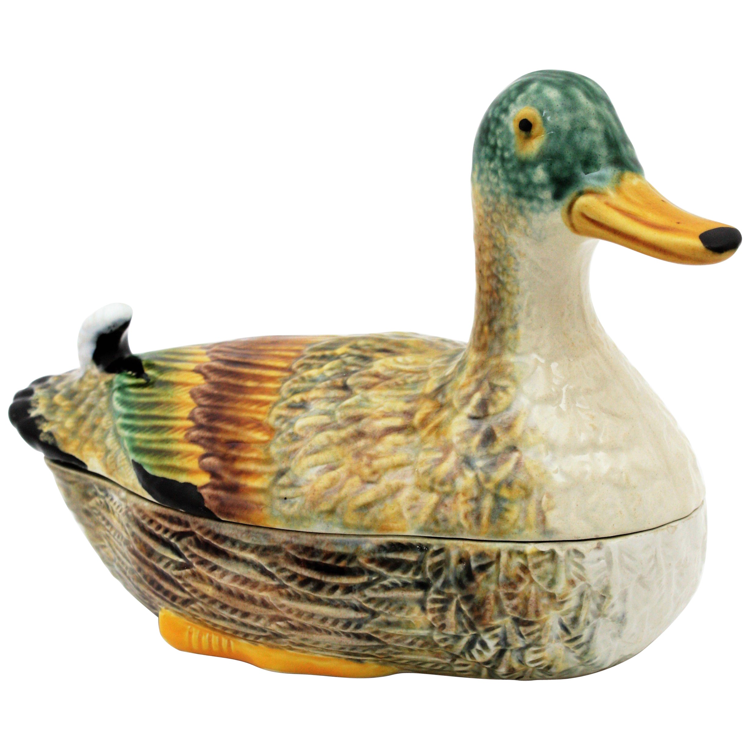 A cool majolica glazed ceramic duck figure tureen in brown and cream colors with accents of black, green and yellow. Portugal, 1960s.
Manufactured by E.Subtil Portugal and marked on the base.
Use it to serve duck foie gras or as candy or chocolates