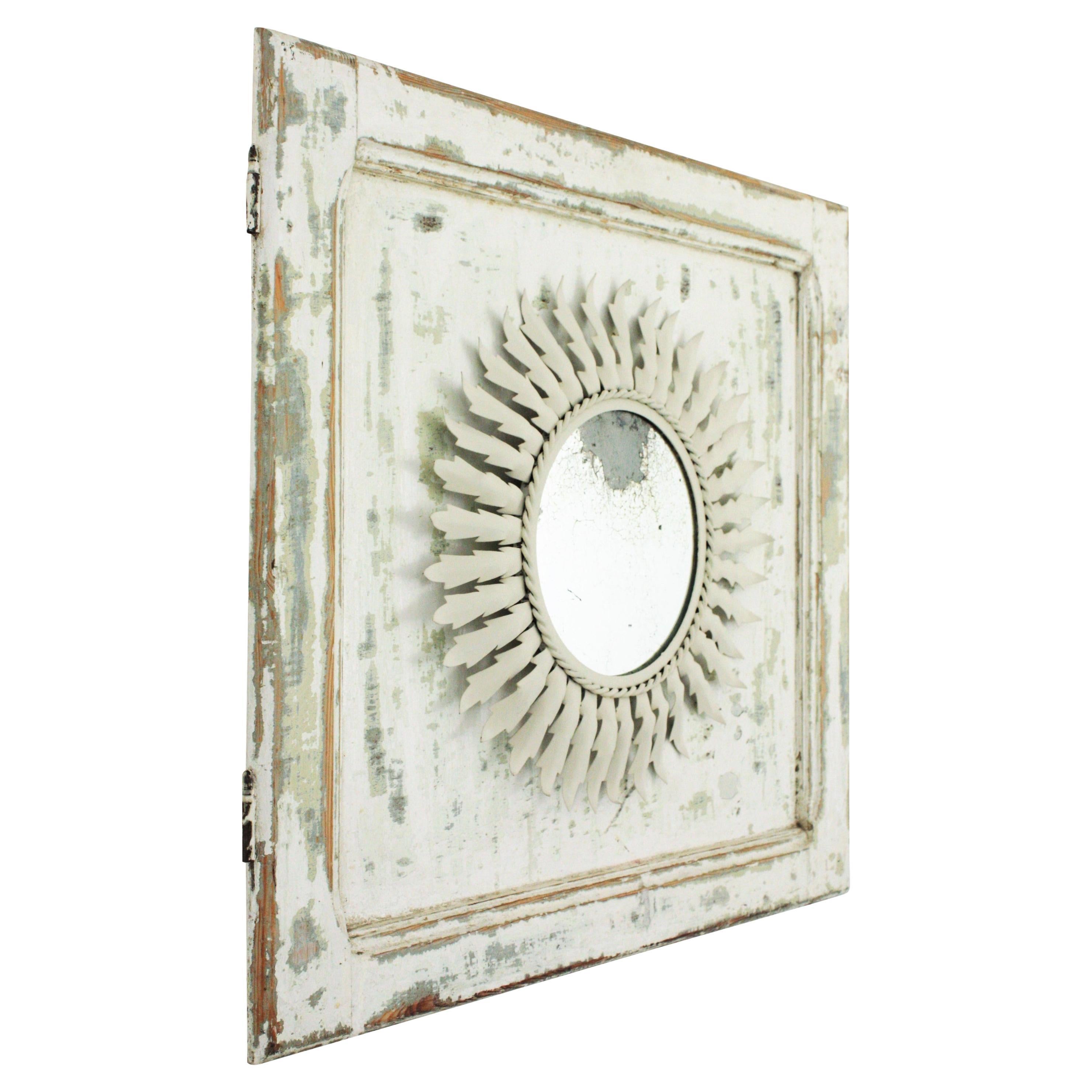 Mid-Century Modern Sunburst Mirror in White Metal Framed by a Wood Patinated Door For Sale