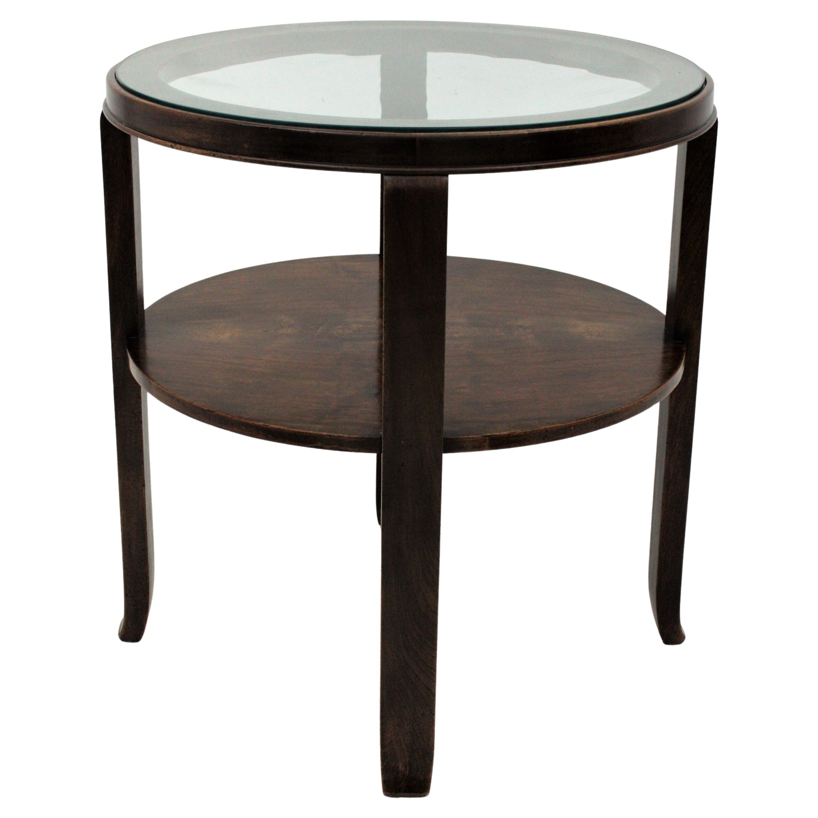 Stylish Art Deco two-tier walnut round gueridon / end or side table with glass top, France, 1930s.
Used as occasional table or drinks table or placed beside a sofa, this table is an elegant choice wherever it is placed.
This table has been carefully