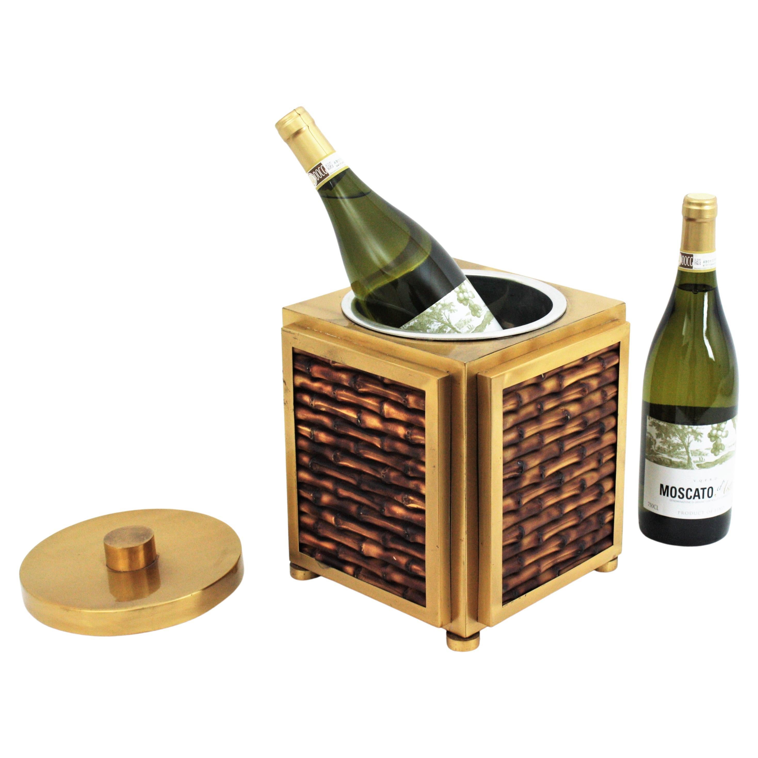 Eye-catching champagne or wine cooler or ice bucket in faux bamboo ceramic and brass, Italy, 1970s.
This cube shaped lidded ice bucket features a cubic construction in brass with faux bamboo ceramic panels on each side. The lid is also made in