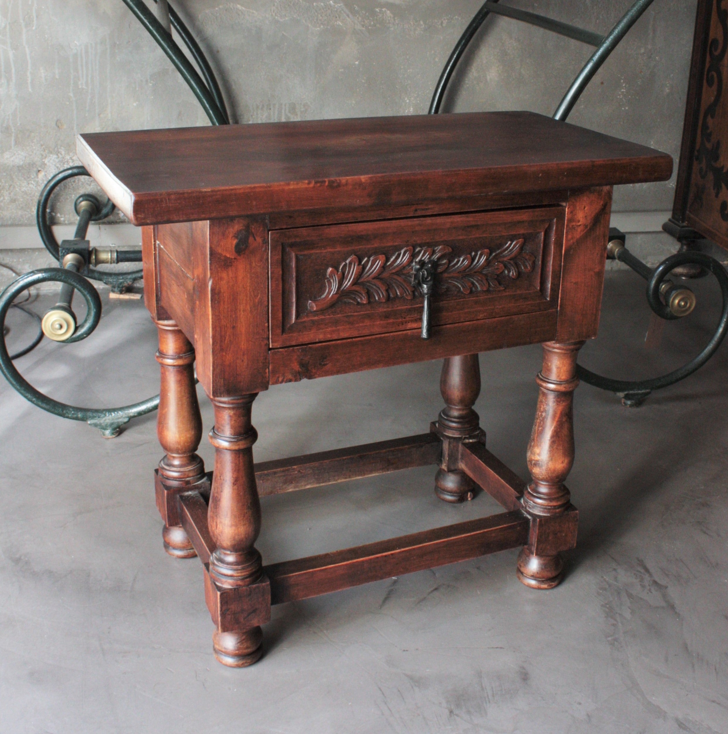 Spanish Walnut Side or End Table with Drawer and Iron Hardware
Walnut Spanish Revival side table with single carved drawer and iron hardware, Spain, 1930s.
This elegant Spanish table features a simple, rectangular top, sitting above a single drawer