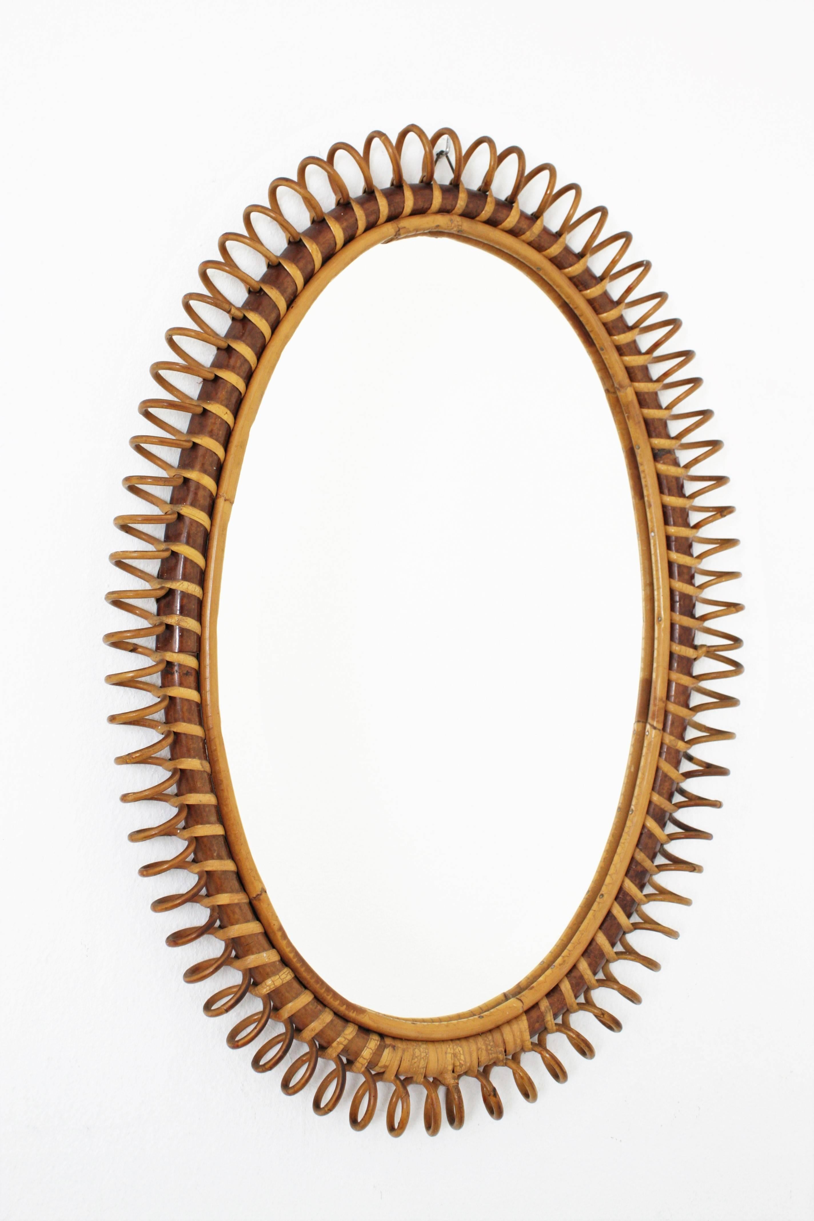 Italian Mid-Century bamboo and wicker helical design framed mirror. Finely hand-curved wicker work. Lovely to place it alone but also gorgeous placed with other mirrors in this manner crating a wall decoration. Italy, 1950s

