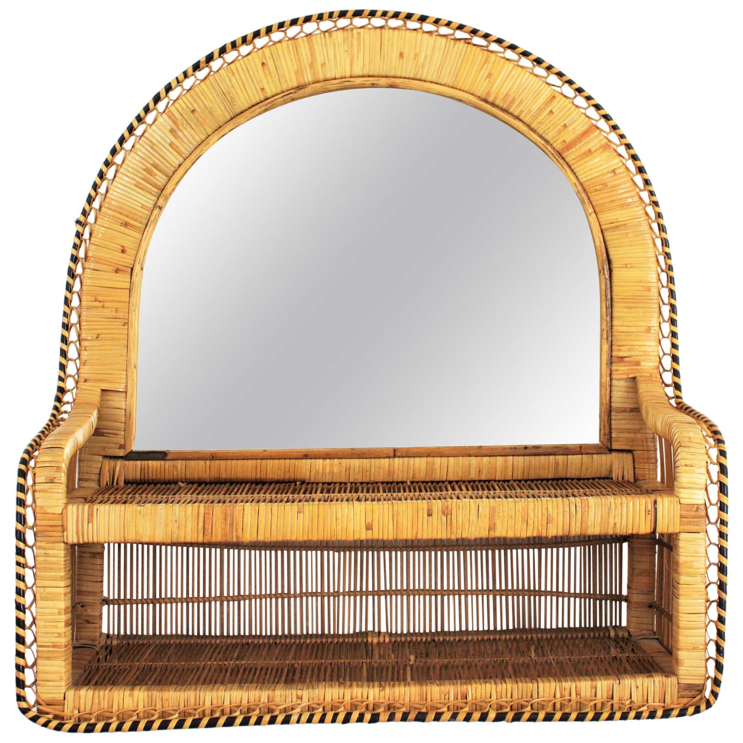 Eye-catching Spanish handwoven bicolor rattan and wicker shelf mirror in the style of the Emmanuelle peacock chair. Spain, 1970s.
The frame has a semi oval shape and a meticulous handcrafted work that makes this piece highly decorative and full of