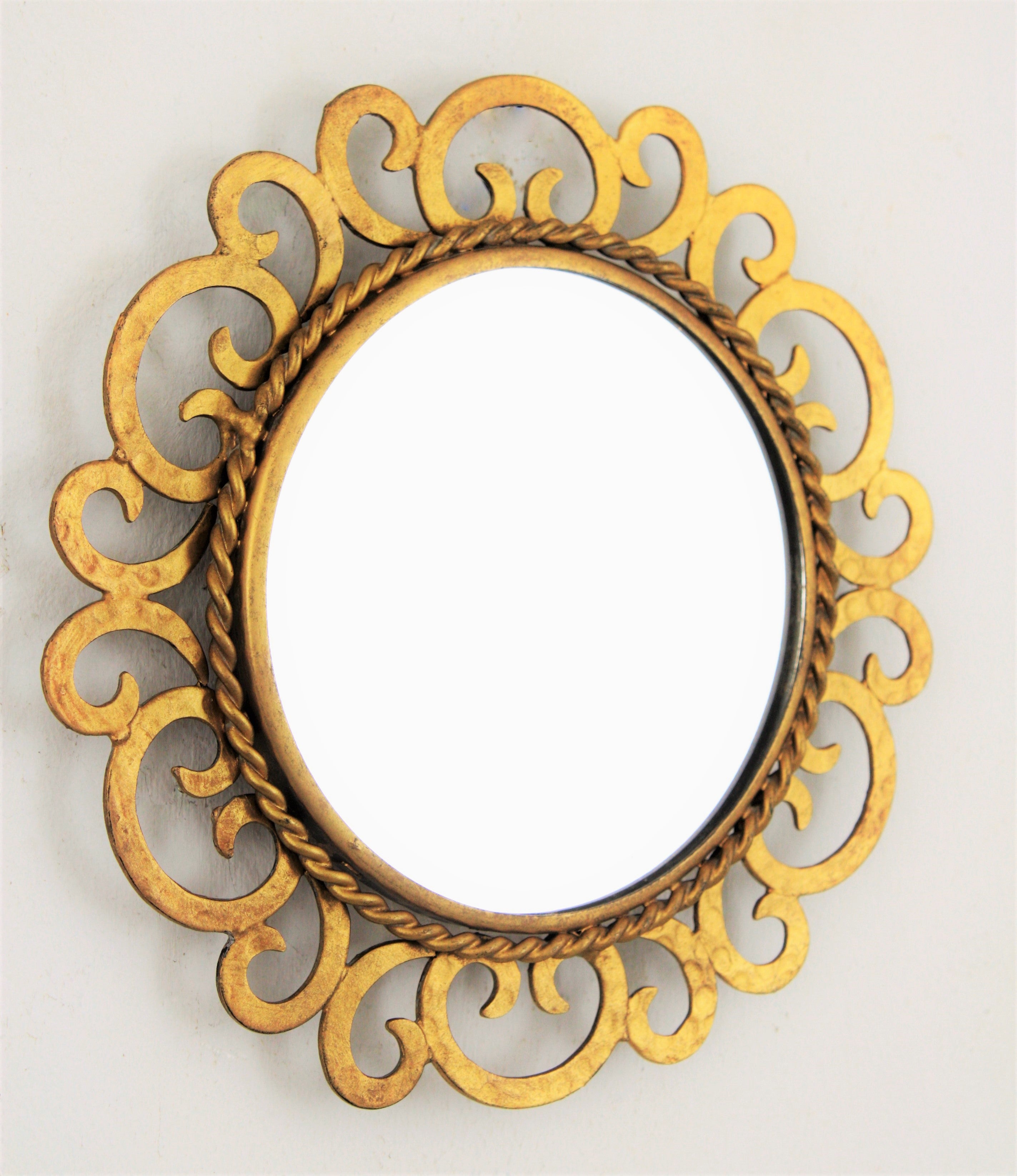 Mid-Century Modern sunburst scrollwork small wall mirror, gilt iron, 1950s
Lovely handcrafted gilt iron sunburst mirror with alternating scroll motif and gilt finish. Unusual in this small size.
Interesting to create a wall composition with other