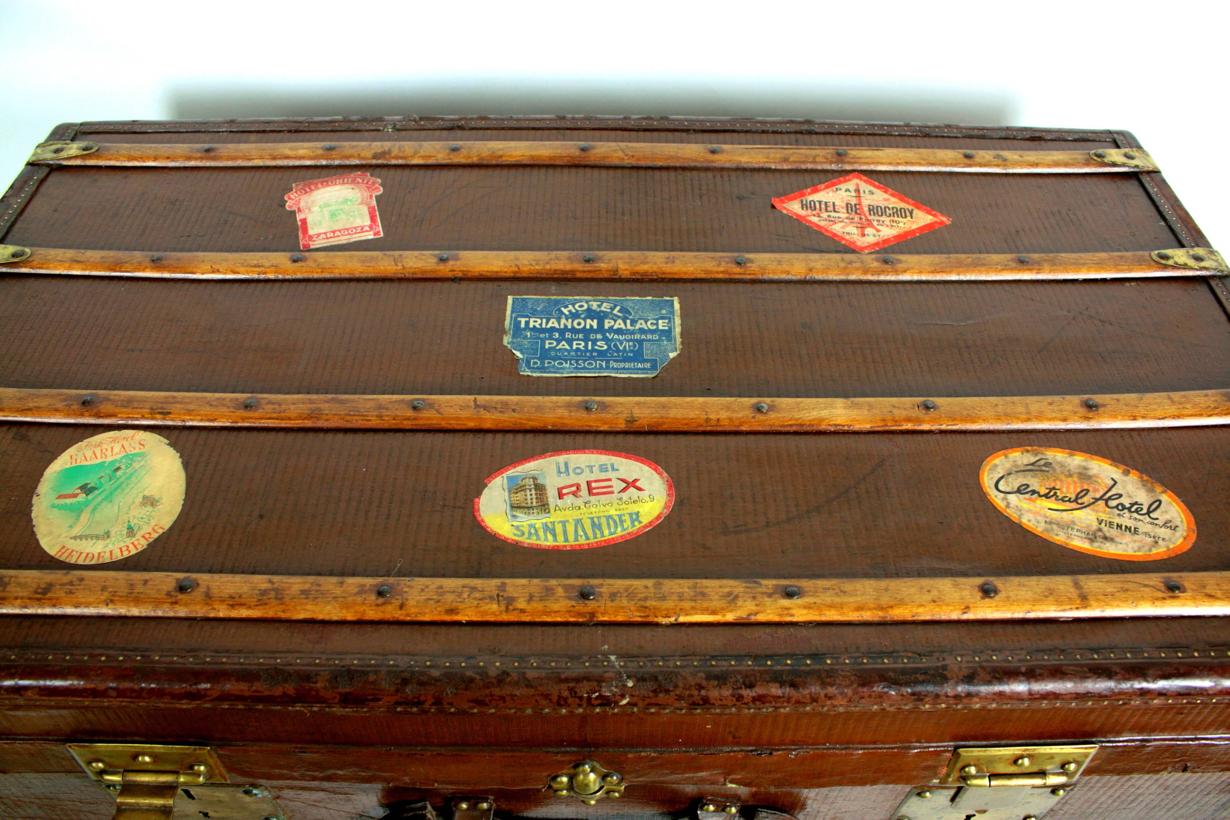 Beautiful steamer trunk made in France at the end of the 19 th c. Decorated with Hotel labels.
Finelly hand crafted with leather handles and corner details. 
Useful as coffee/ side table. Wheels are contemporary.

Avaliable other pieces of antique