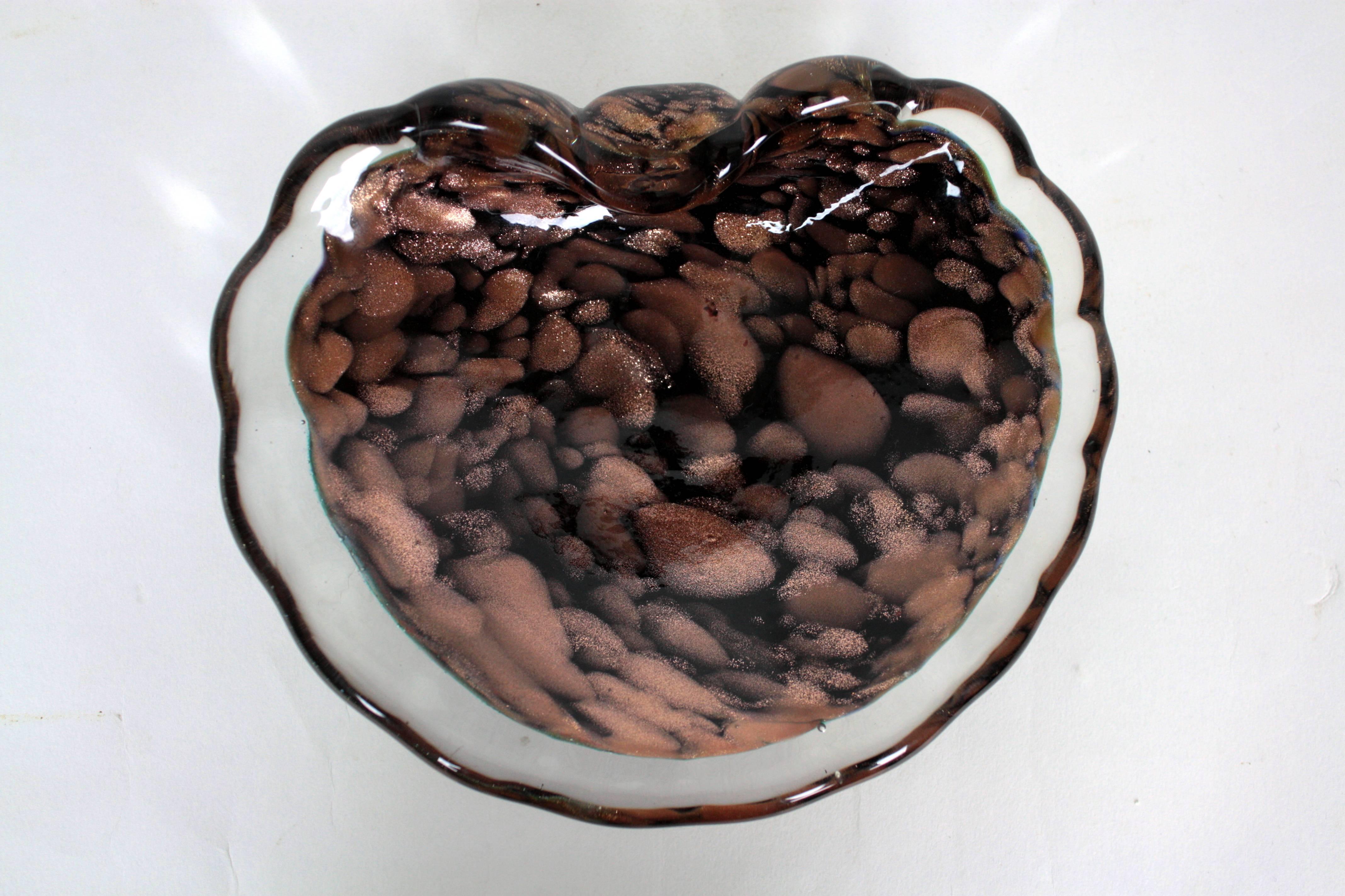 Whimsical scalloped shell bowl by Vincenzo Nason.

Vincenco Nason worked for Venini glass before he established his art glass company. The use of black glass and copper aventurine is the identity sign of the company.