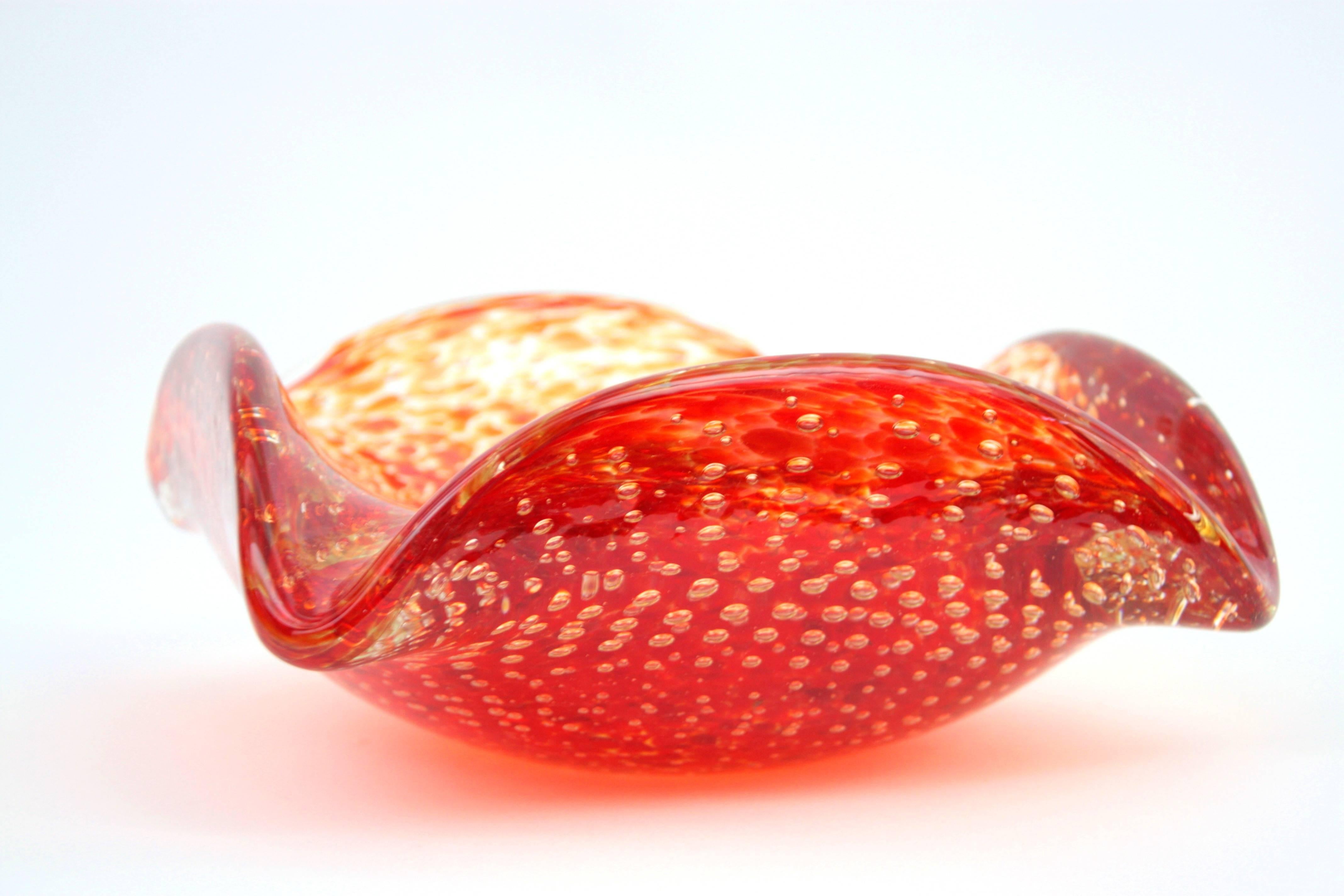 A gorgeous Murano art glass piece with bullicante technique. Very big size. Red and orange glass decorations cased in clear glass. Amazing shapes, very decorative,
Murano, circa 1960.

Please kindly check other Murano glass pieces available in