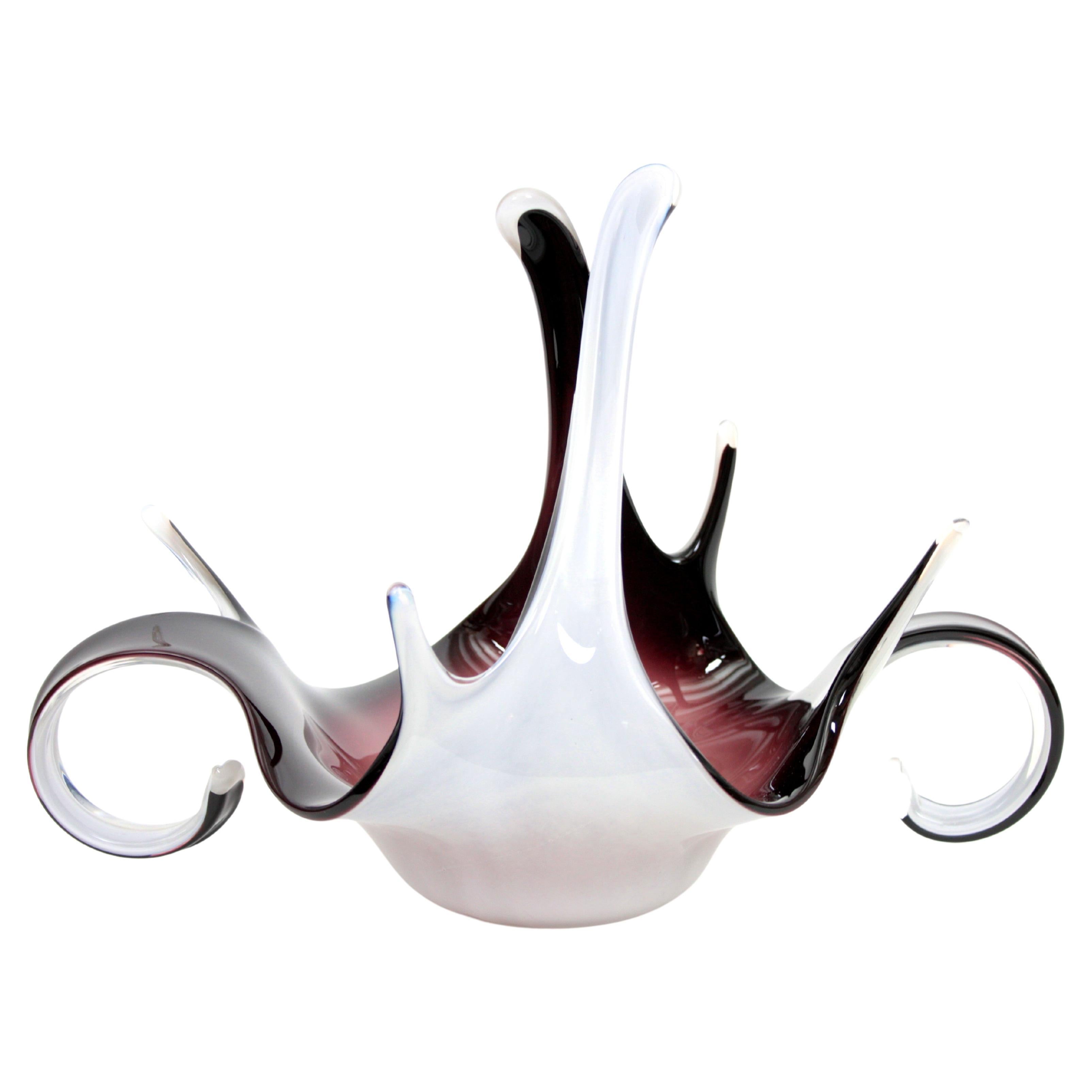 Italian Mid-Century Modern purple and white murano glass free form centerpiece. Italy, 1960s
A highly decorative and sculptural Murano glass centerpiece made in shades of garnet and pink at the interior part and white glass at the exterior