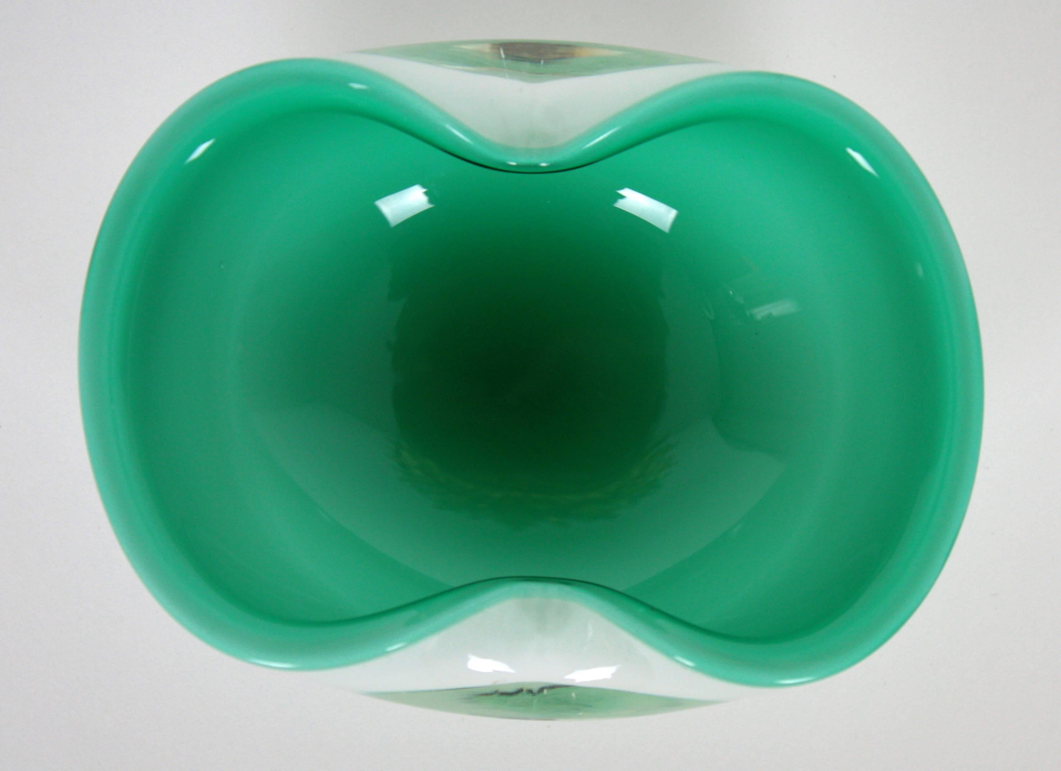 Amazing Murano glass bowl in a beautiful aqua green color and white glass cased into clear glass,
Italy, 1950s-1960s.