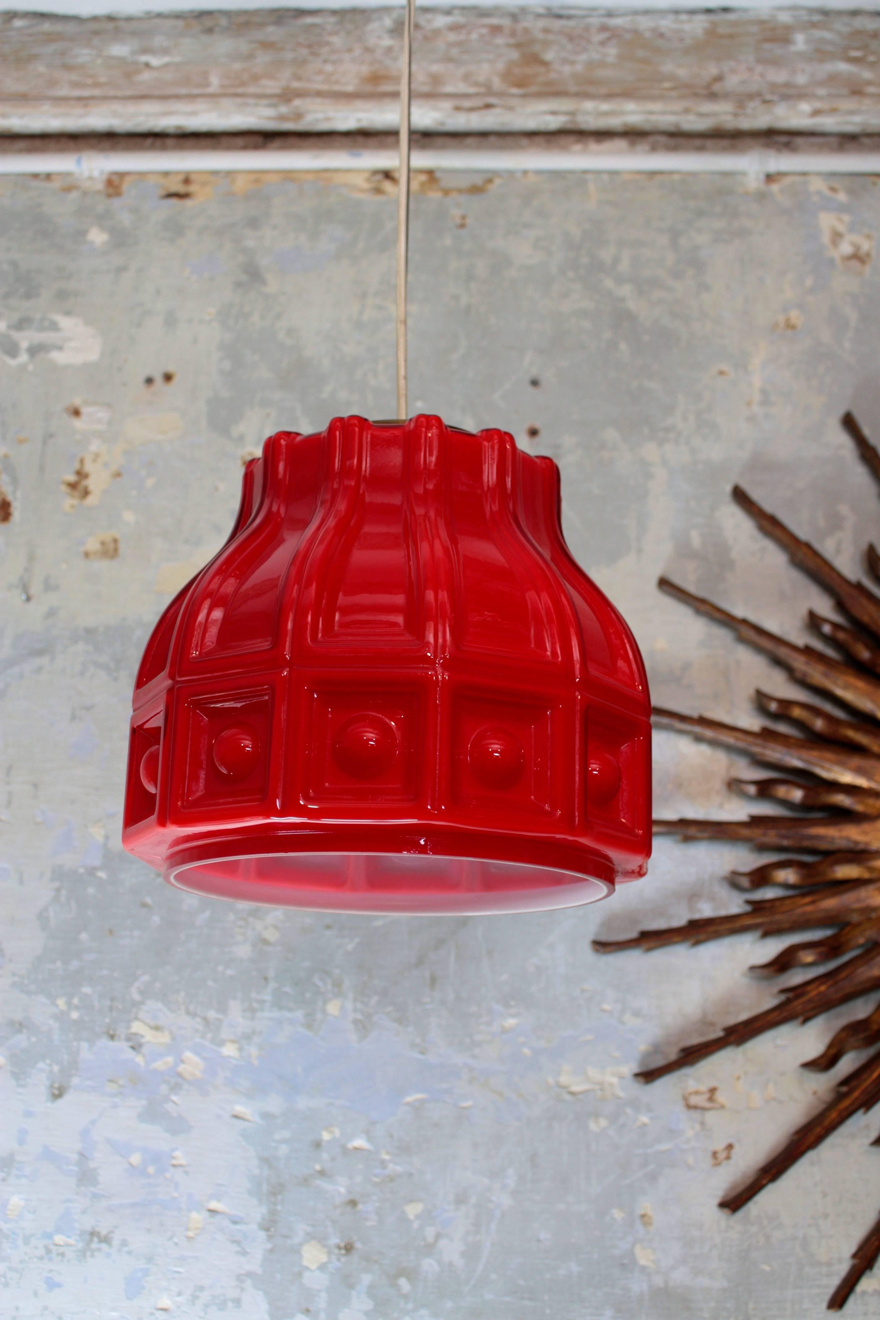 Helena Tynell Midcentury Modern Red Glass Pendant Lamp for Flygsfors. Sweden, 1960s.
Designed by Helena Tynell and Manufactured by Flygsfors, 
Double layers of blown glass, the exterior part in a vibrant red color and the interior part in
