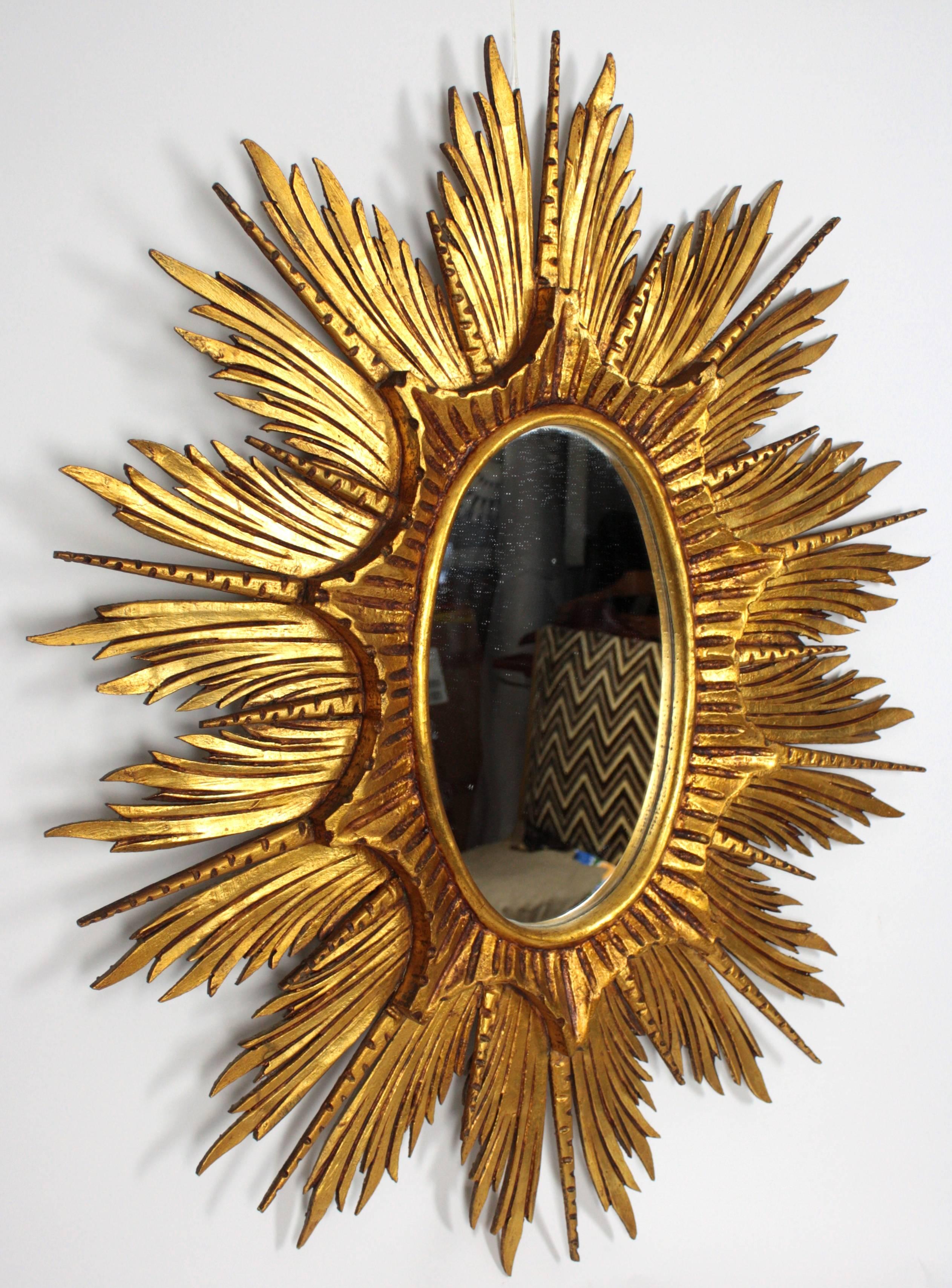 Hollywood Regency Large Spanish Carved Giltwood Sunburst or Starburst Oval Mirror