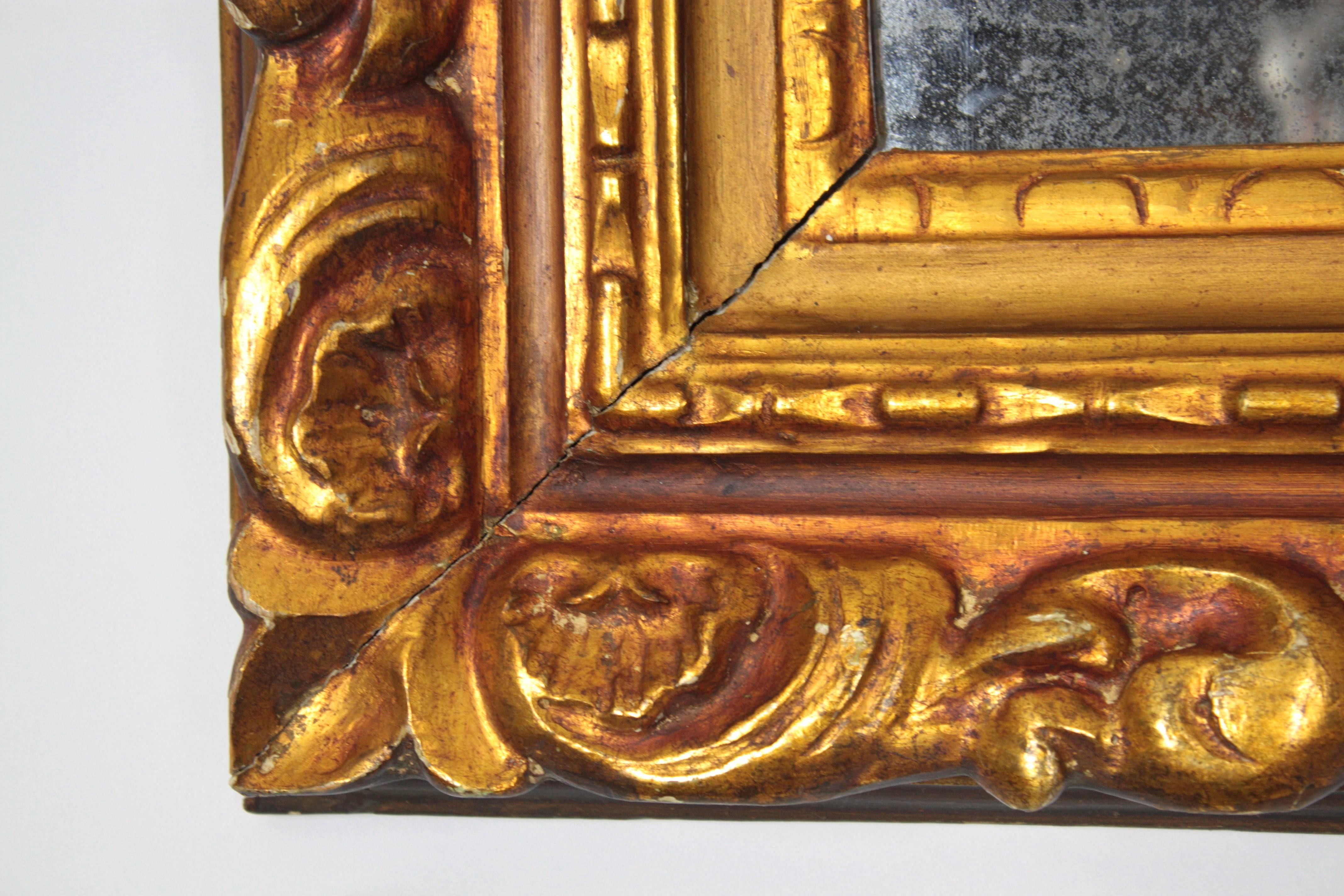 Amazing wood carved frame with gold leaf finish in Baroque style,
Spain, early 20th century.
Original glass with terrific patina. Beatiful foliage carving details on the frame.
Also beautiful used to frame a picture.
Measures: 42 cm W x 34 cm H  //