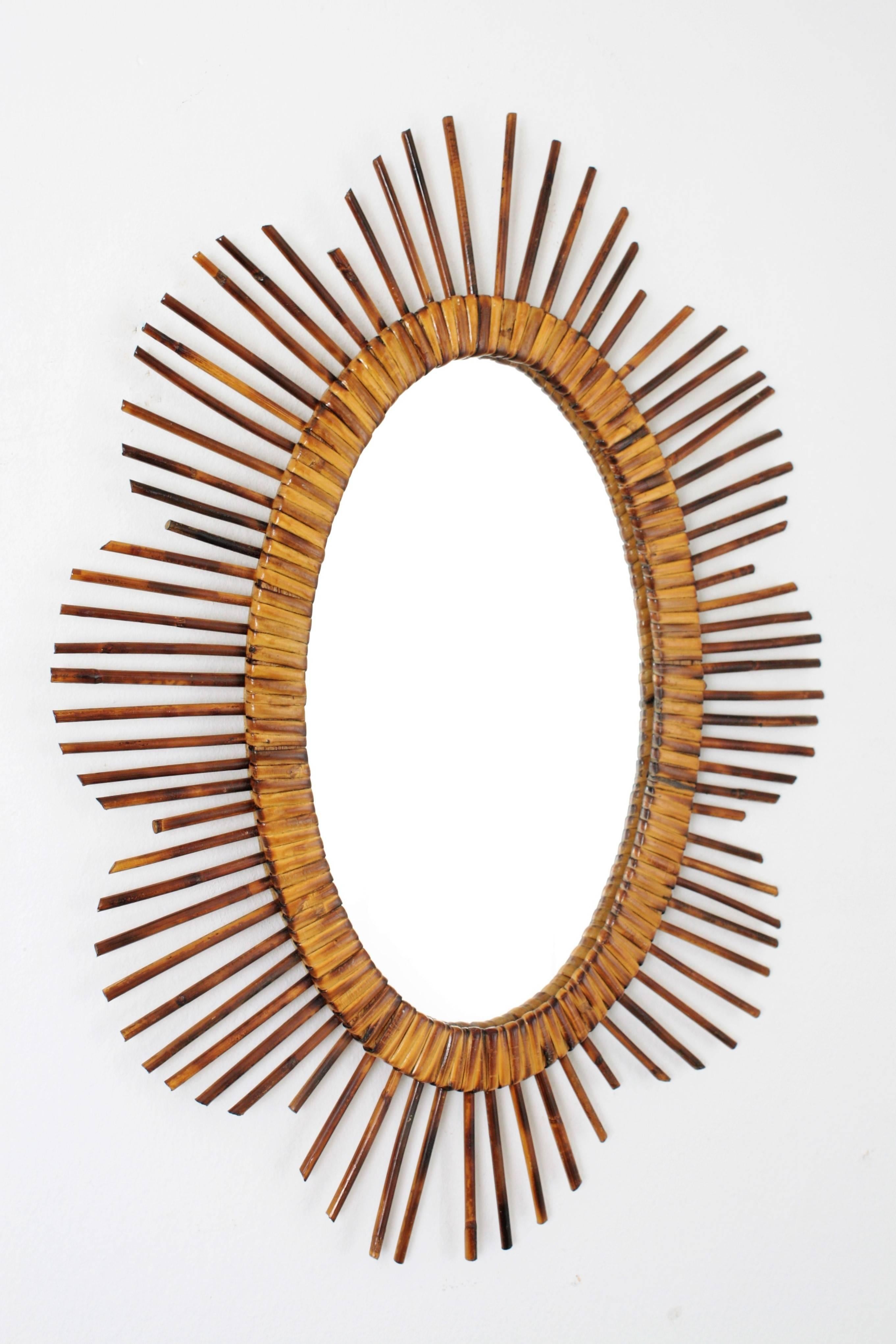 Amazing handcrafted rattan sunburst or flower burst oval mirror with pyrography decorations.
Beautiful to place it alone or creating a wall decoration with other mirrors in this manner.
France, 1950s-1960s.