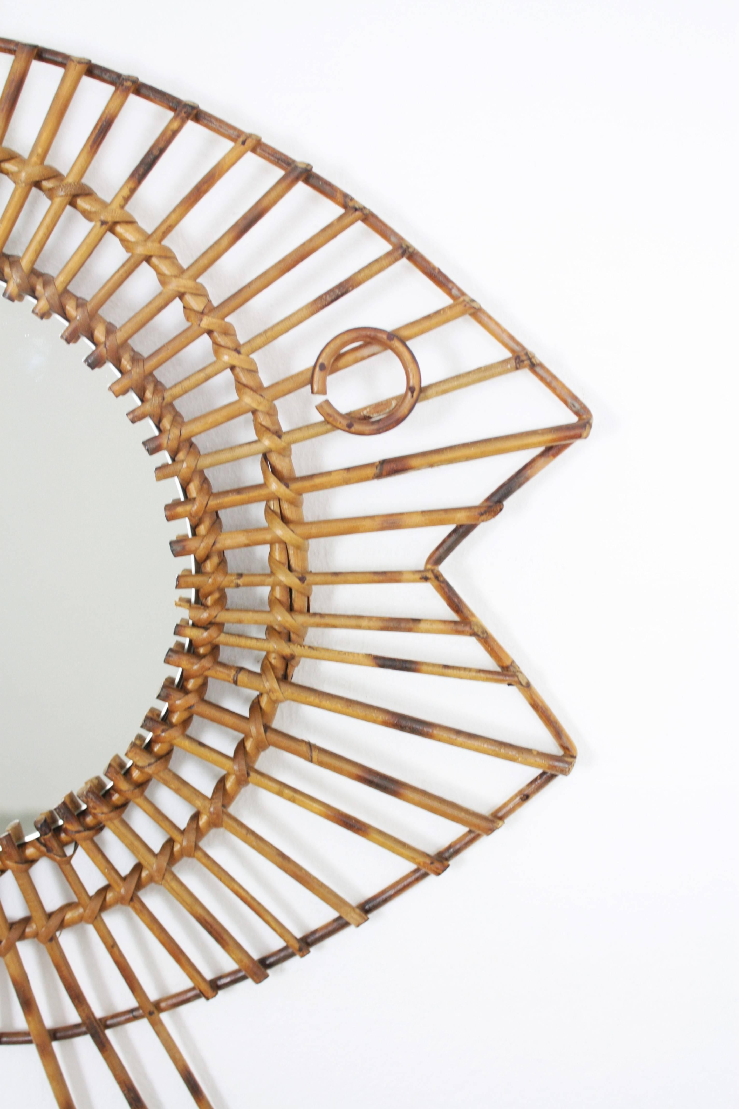 Unusual 1950s French rattan or wicker mirror handcrafted with fish shape and oriental accents. This spectacular piece combines accents from the French Riviera style and oriental accents.
Excellent vintage condition.
France, 1950s.
Dimensions of