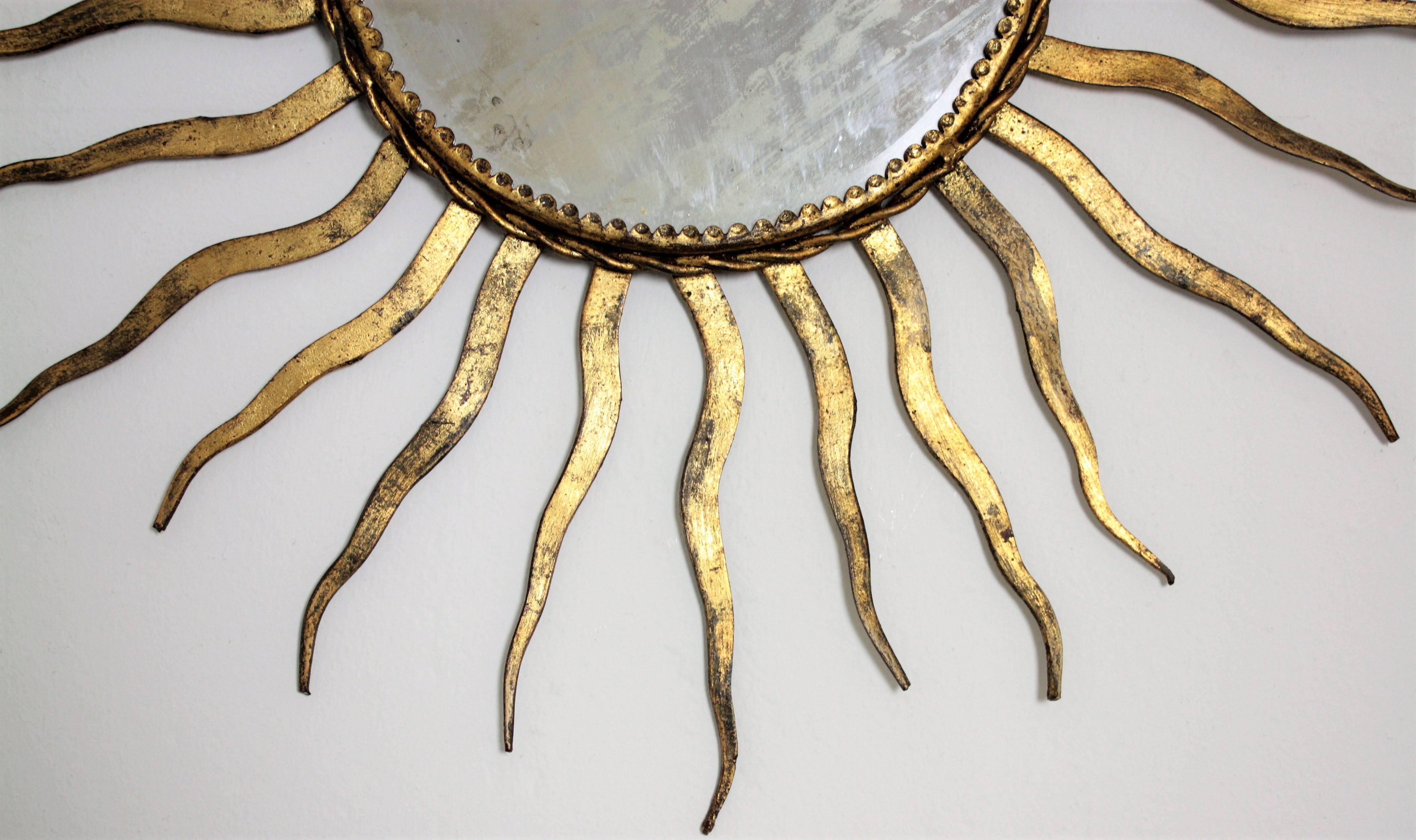 French 1950s Wrought Gilt Iron Sunburst Mirror in the Style of Gilbert Poillerat In Excellent Condition In Barcelona, ES