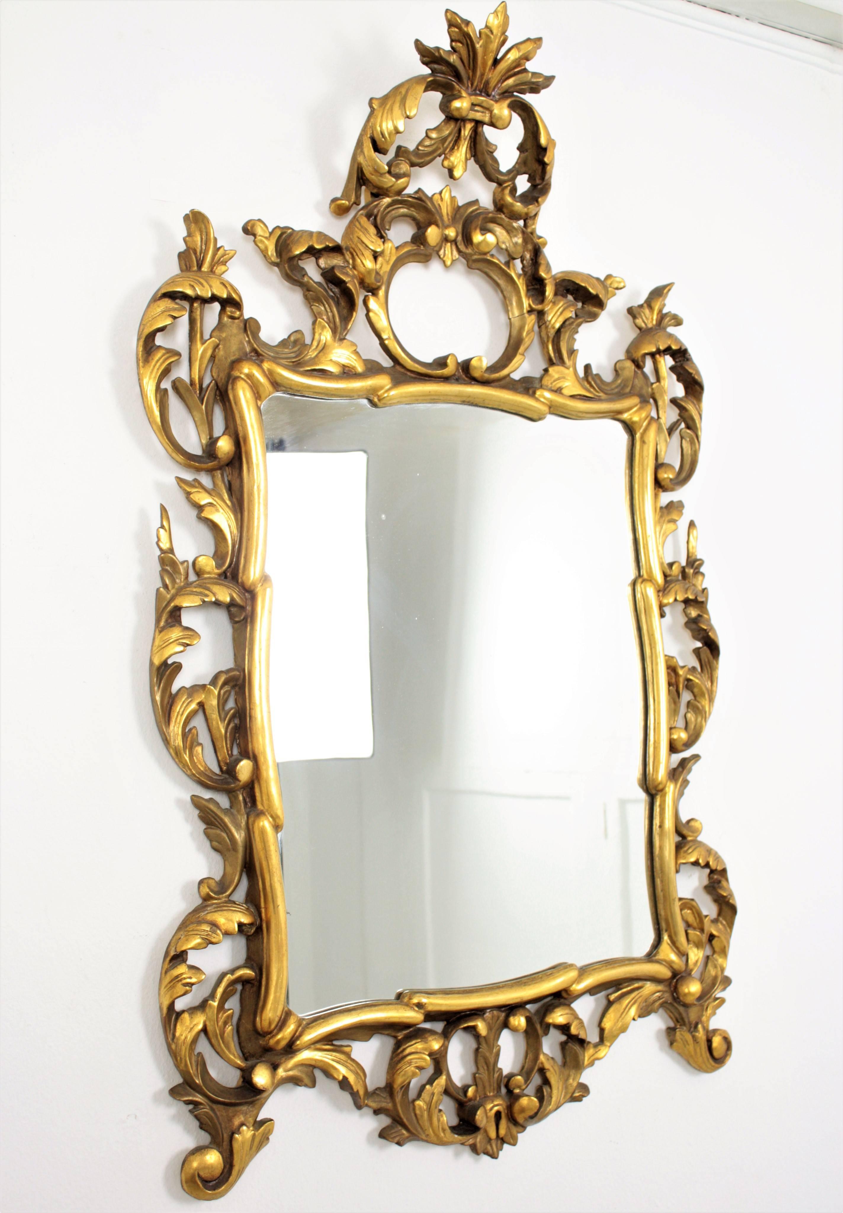 A finely carved and highly decorative Rococo style mirror with gold leaf finish and beautiful original patina. Frame with details of scrolled acanthus leaves and an important carved crest,
Spain, circa 1890.

Avaliable a huge collection of