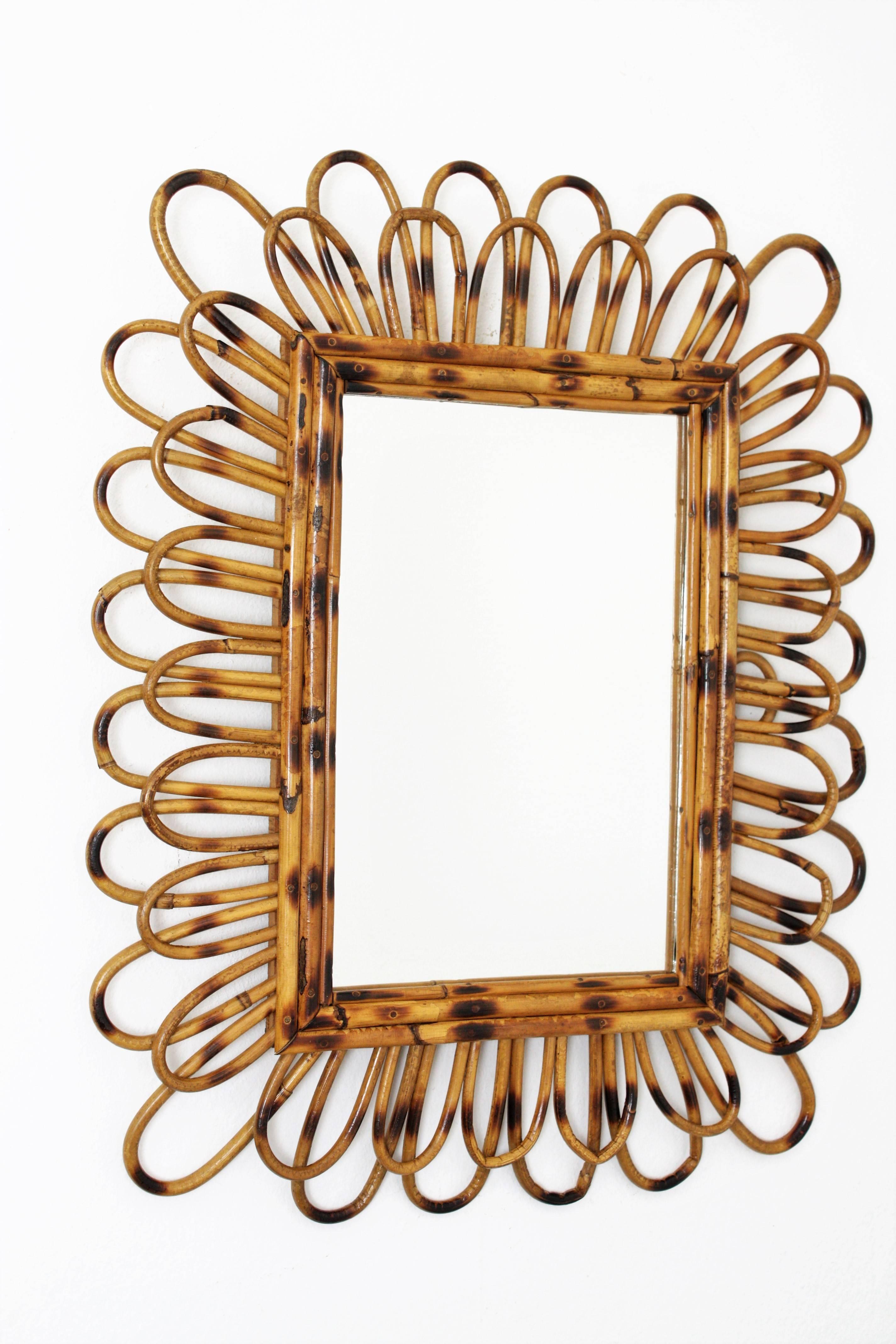 A lovely Mediterranean style cane mirror handcrafted in Spain at the 1960s. It has pyrography details on the frame. Beautiful to create a wall decoration with other mirrors in this manner. It can be hung in two positions.
Spain, 1960s.

Available