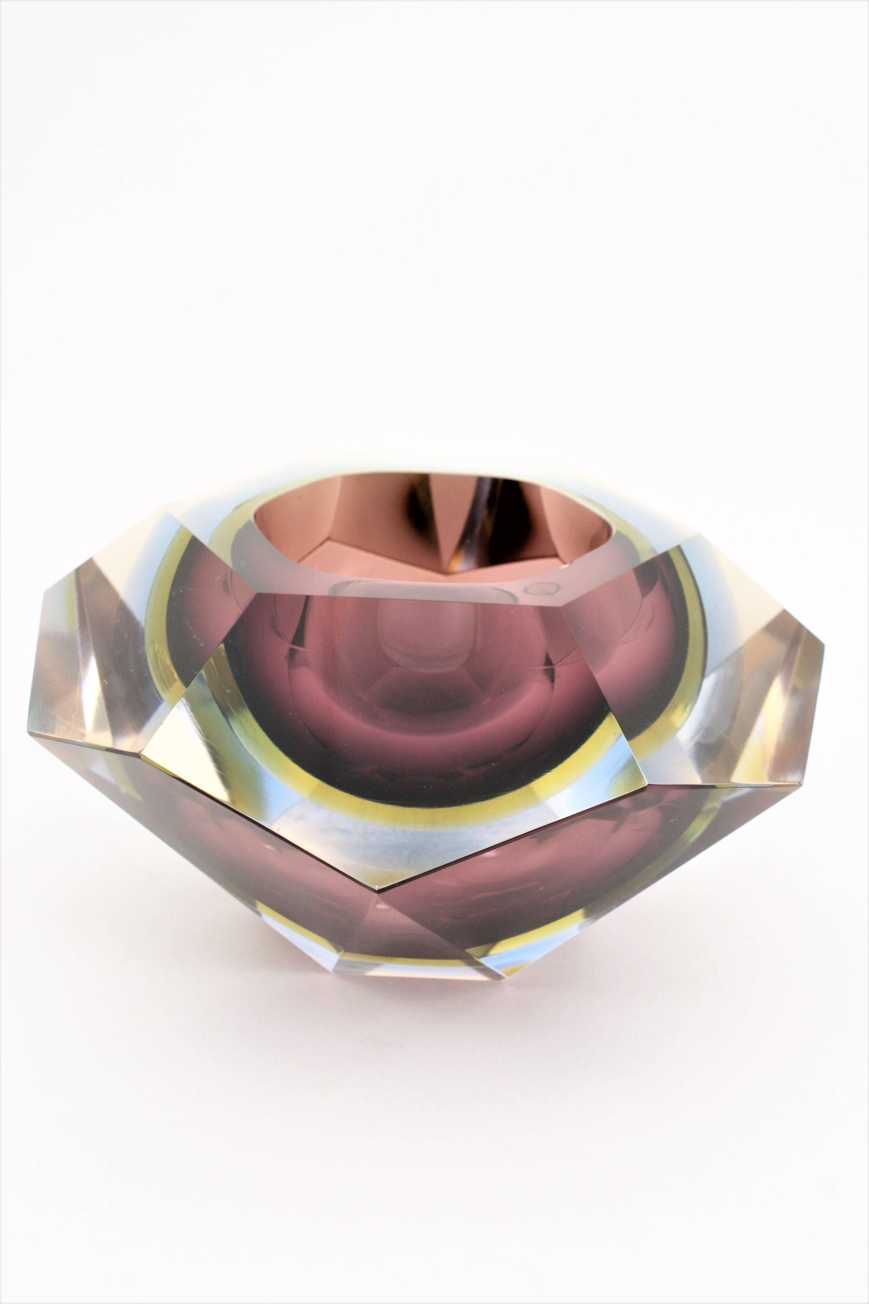 A monumental Sommerso faceted Murano glass bowl or centerpiece. Garnet, yellow and blue triple cased glass in clear class, faceted diamond shape and an unusual extra large size. This is the bigger size in this design we have ever seen. Attributed to