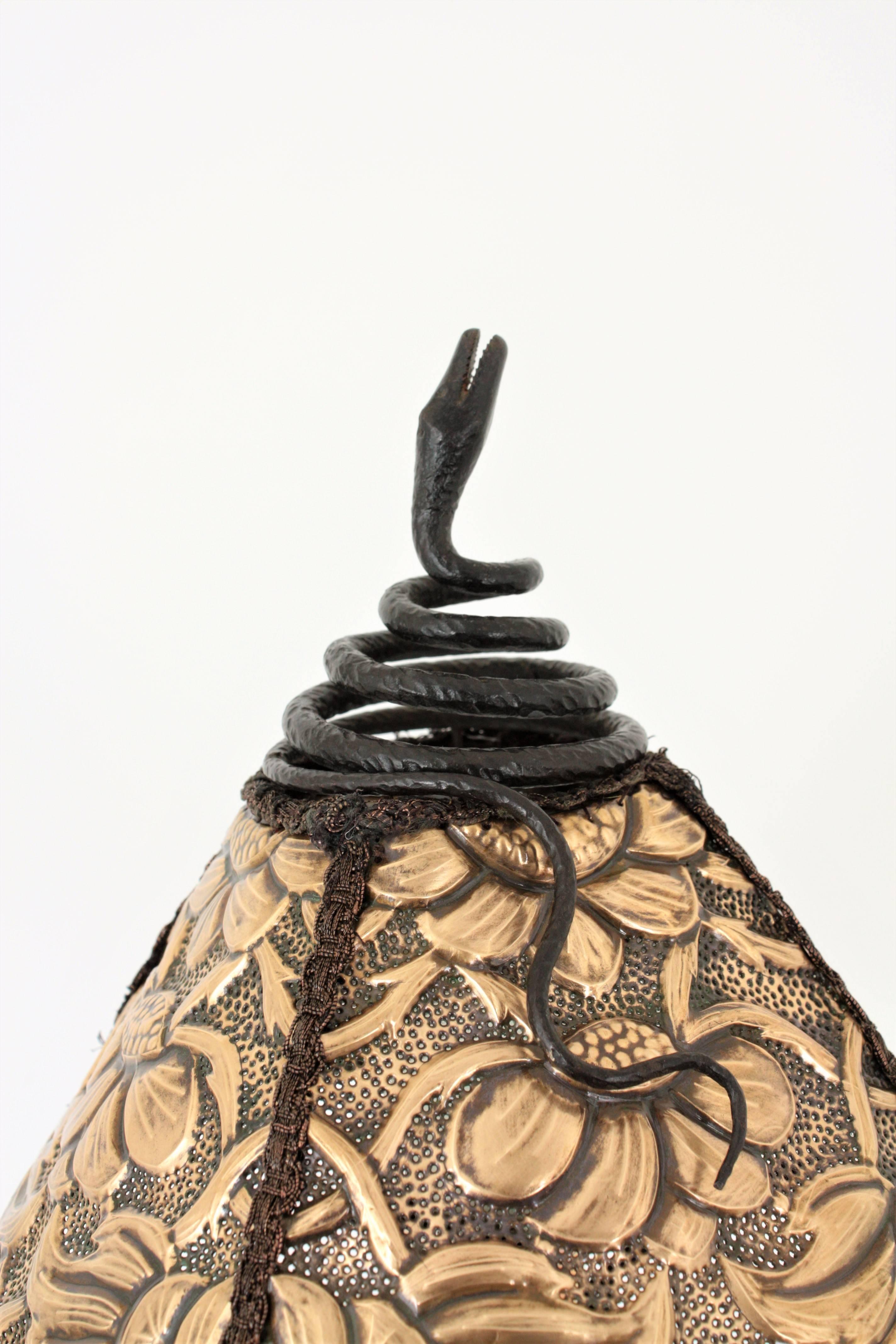 Unique Art Nouveau hand-hammered iron sculptural table lamp from Barcelona. Early 20th century, Spain.
This amazing hand forged piece is made in the manner of Antoni Gaudí iron designs. The lamp is decorated by an iron figure of a snake and