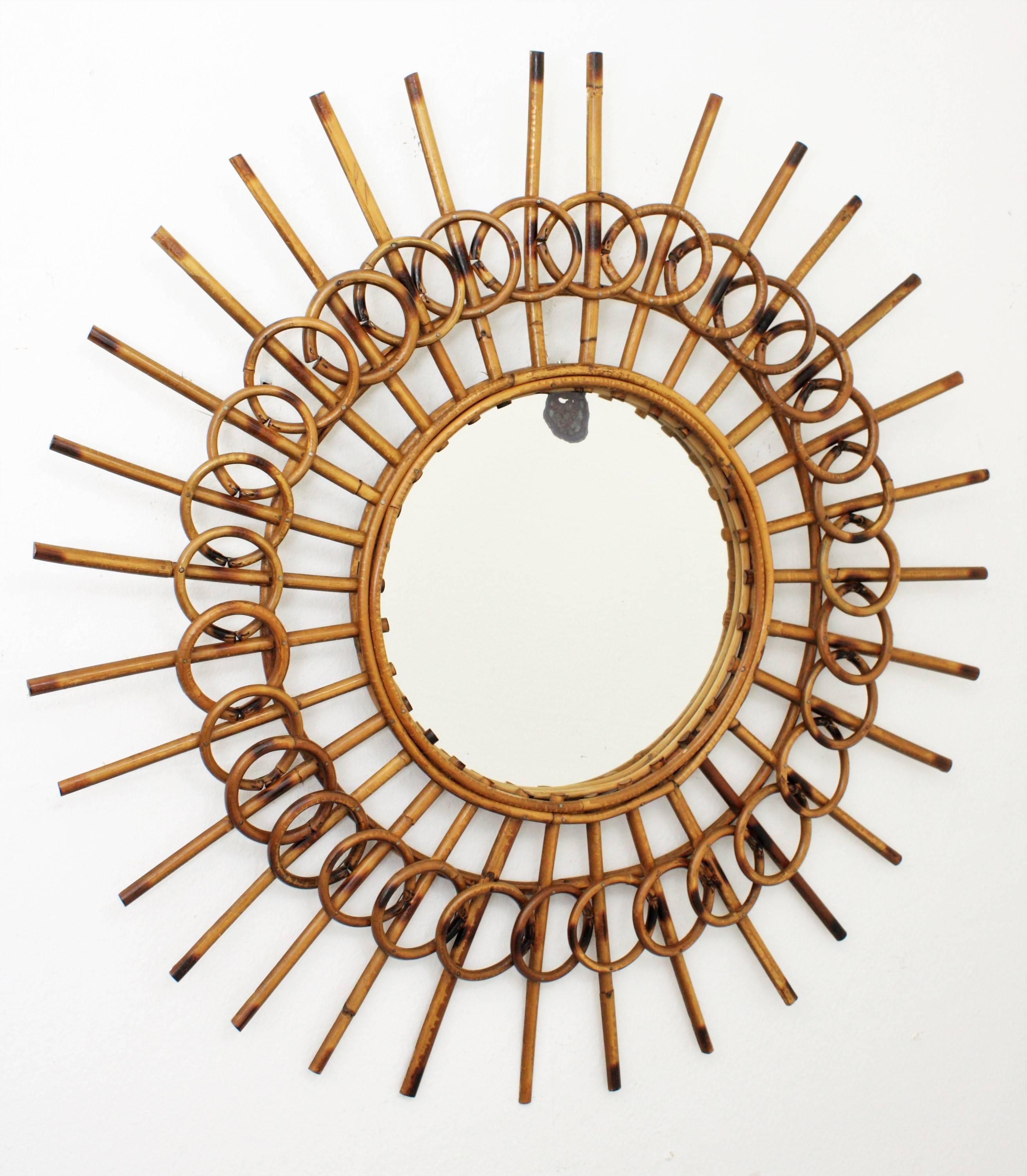 A highly decorative rattan sunburst mirror framed by circles with a lovely color.
This mirror has the French Riviera Mediterranean taste with an unusual handcrafted beautiful work.
Lovely to place it alone or in a wall decoration with other