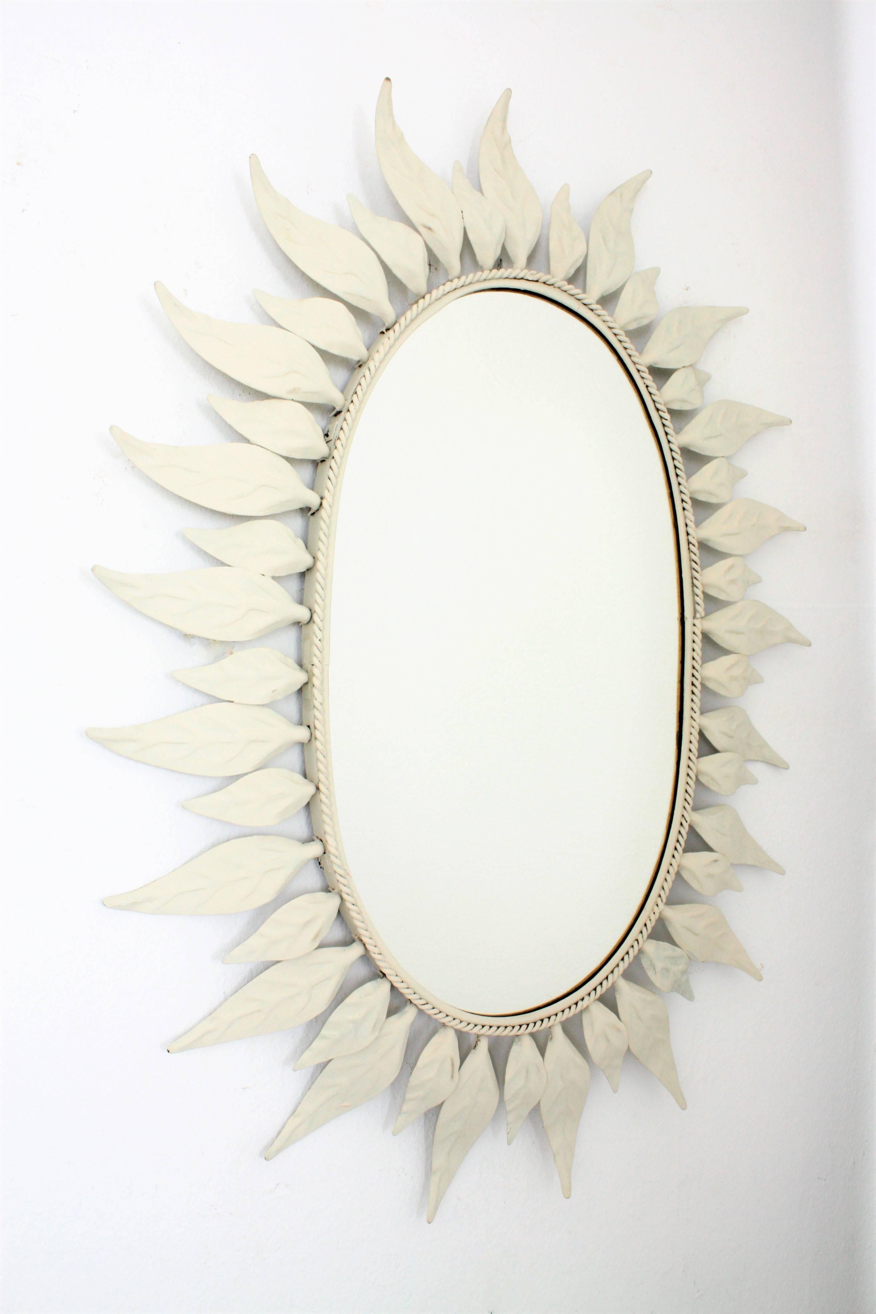Lovely oval sunburst or flower burst mirror with a frame of leaves in two sizes and a white painted finish. Spain, 1960s.
Beautiful to create a fresh wall decoration with other mirrors in soft colors and also mixed with bamboo and wicker