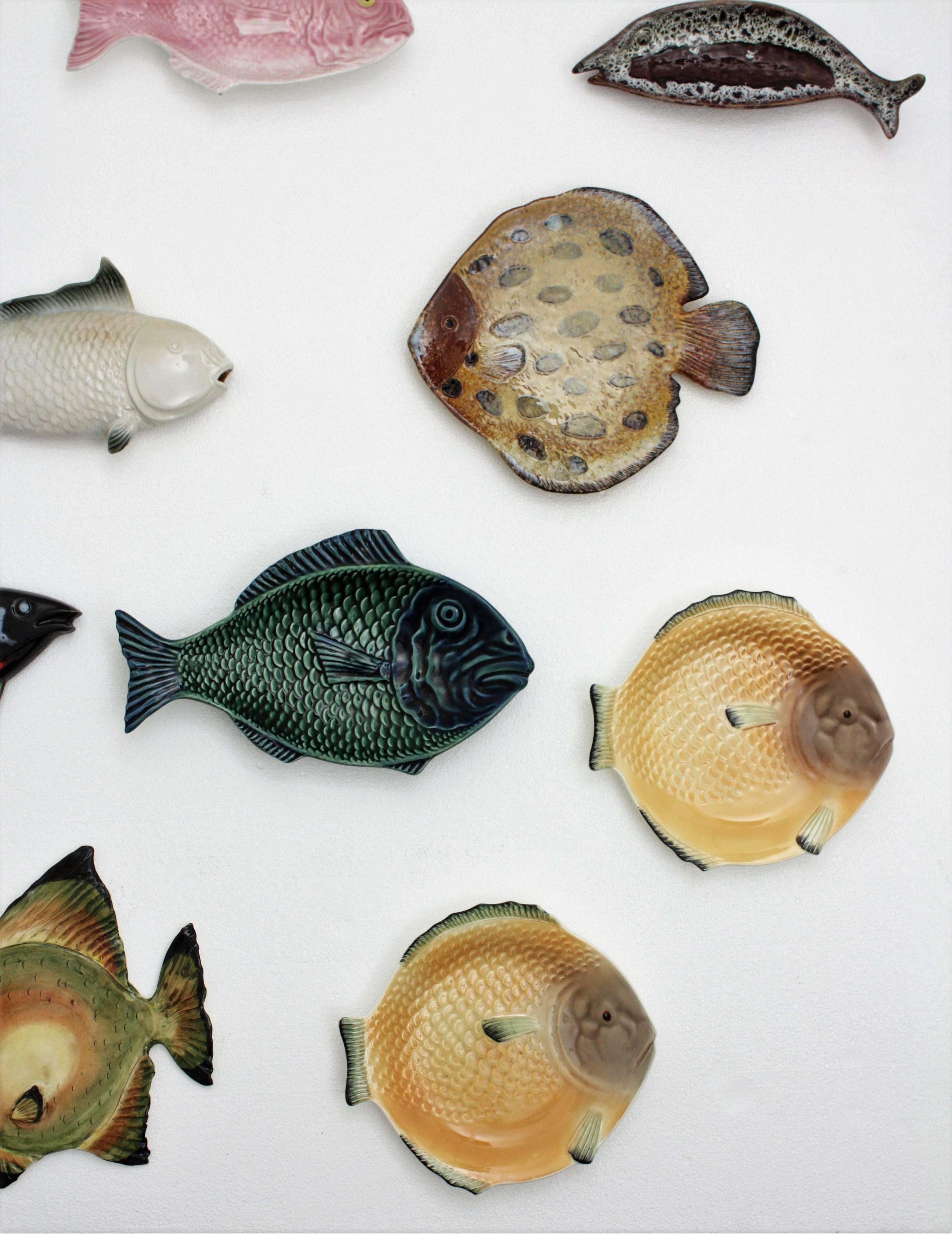 A beautiful collection of nine European glazed ceramic and porcelain fishes in different shapes and sizes from France, Portugal, England and Spain from the period 1930s-1960s. This set is composed by colorful fish trays and plates, and fish wall