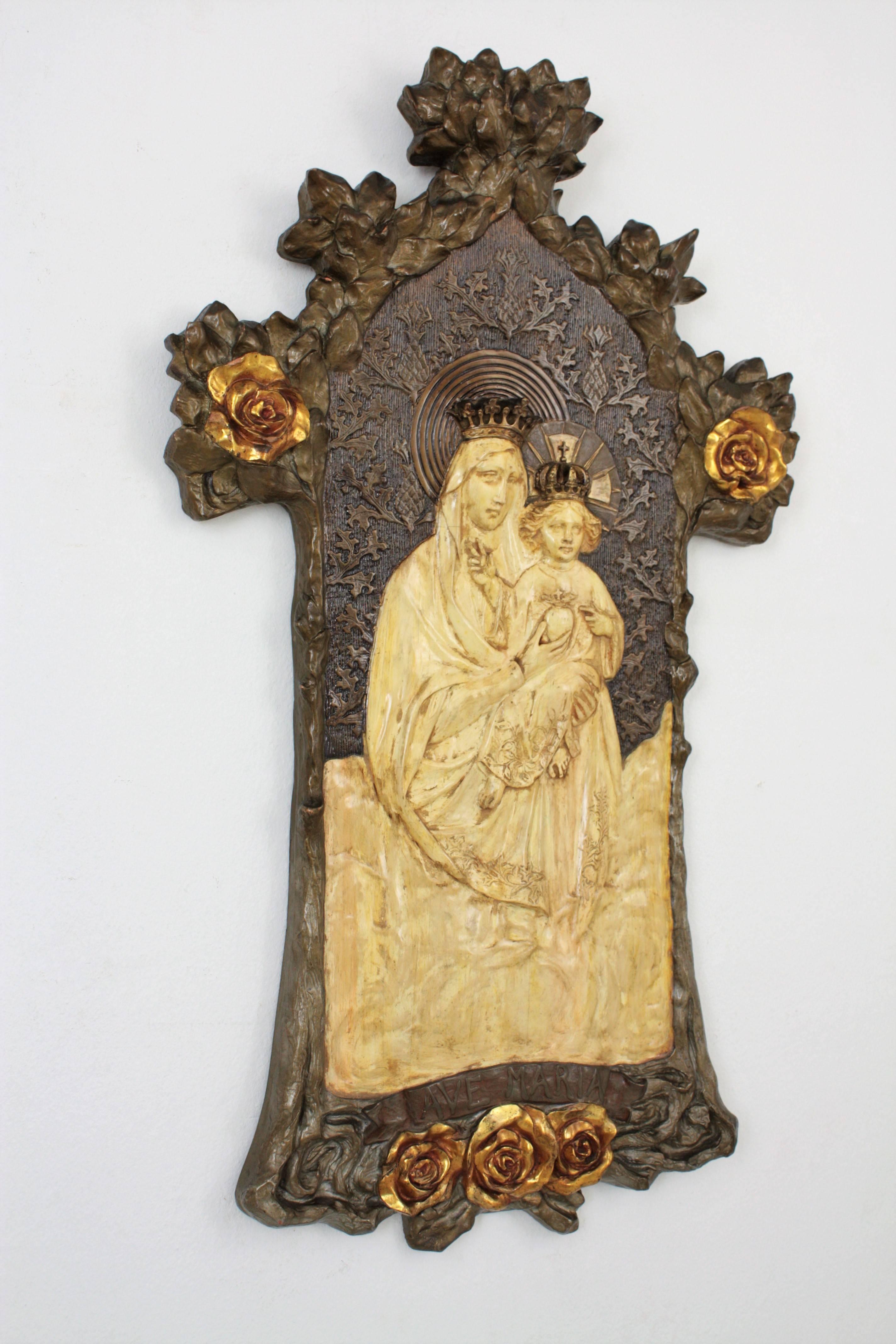 Interesting Antoni Gaudí style Art Nouveau bas relief depicting the virgin and child using molded stucco with polychrome technique and gold leaf accents. This piece has an exquisite molded work with naturalistic ornamentation and gold leaf