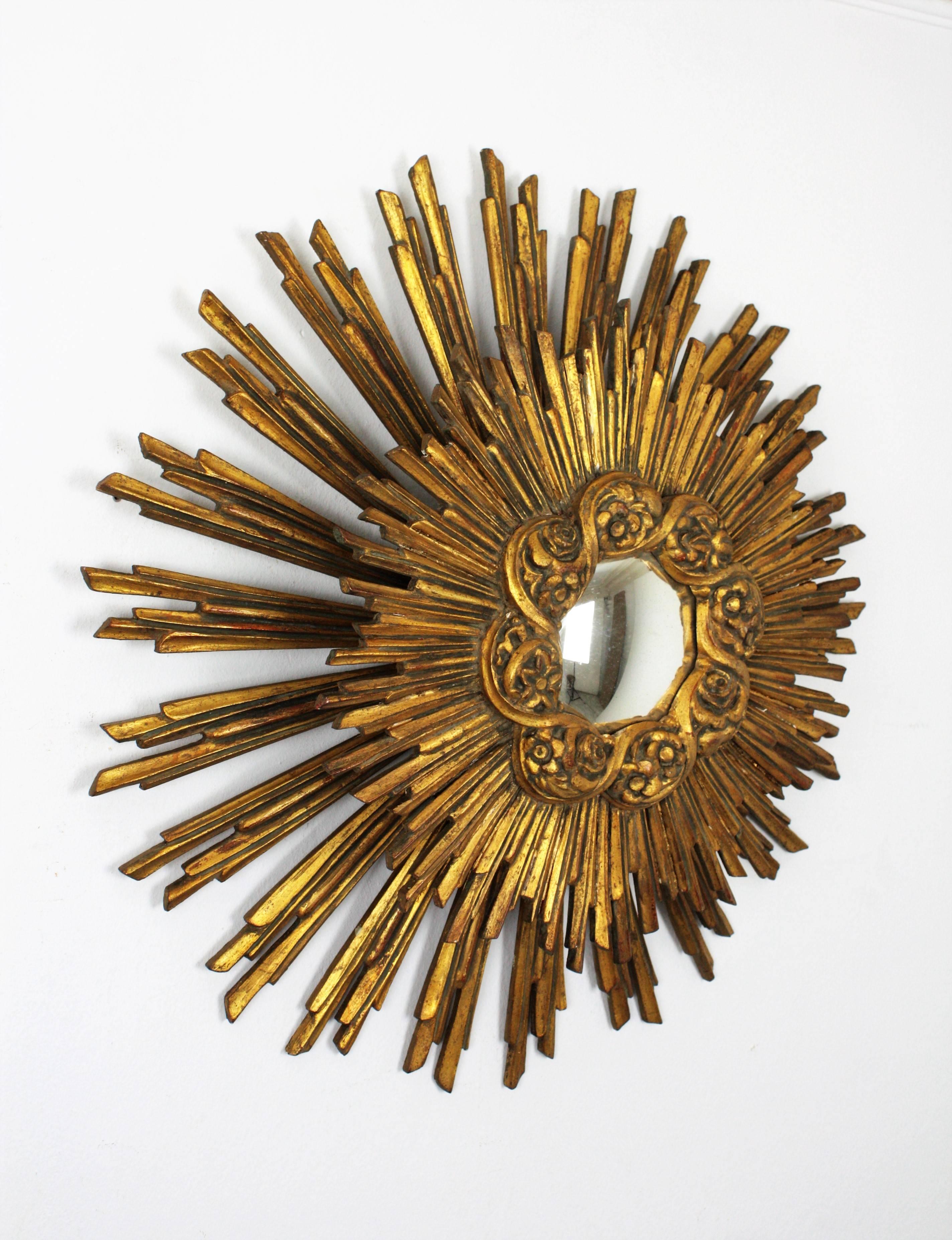 A mangiest double layered wood carved sunburst mirror with gold leaf finish and convex glass that it is also a wall light sconce or a ceiling light fixture.
This piece is gorgeous due to its size and the interesting light effect when lit.
The